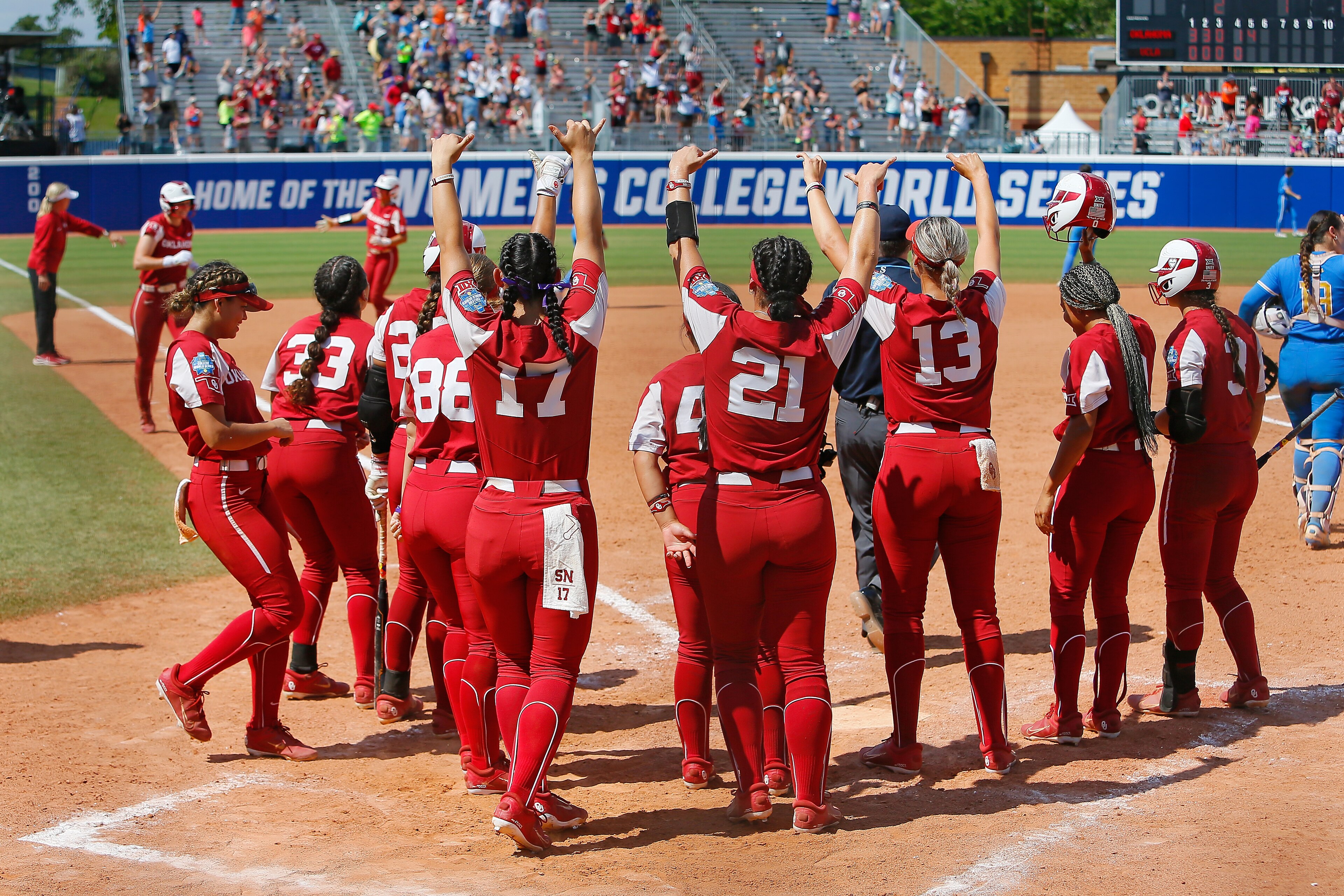 OKLAHOMA CITY, OK - JUNE 6: The Oklahoma Sooners gather around the plate to welcome Jocelyn Alo #78 after her grand slam against the ULCA Bruins in the fifth inning during the NCAA Women's College World Series at the USA Softball Hall of Fame Complex on June 6, 2022 in Oklahoma City, Oklahoma. Oklahoma won the elimination game 15-0. (Photo by Brian Bahr/Getty Images) OKLAHOMA CITY, OK - JUNE 6: The Oklahoma Sooners gather around the plate to welcome Jocelyn Alo #78 after her grand slam against the ULCA Bruins in the fifth inning during the NCAA Women's College World Series at the USA Softball Hall of Fame Complex on June 6, 2022 in Oklahoma City, Oklahoma. Oklahoma won the elimination game 15-0. (Photo by Brian Bahr/Getty Images)