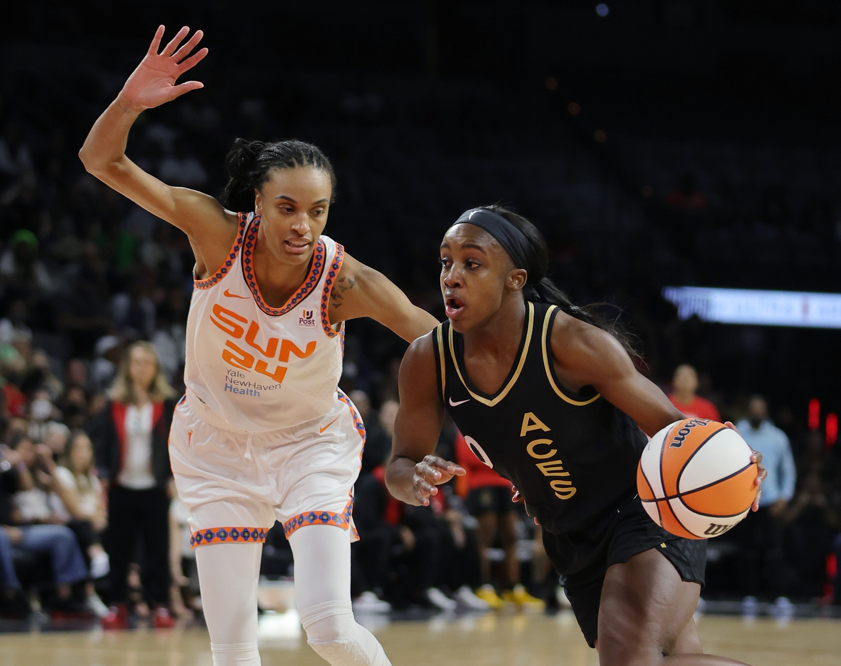 LAS VEGAS, NEVADA - JUNE 02: Jackie Young #0 of the Las Vegas Aces drives against DeWanna Bonner #24 of the Connecticut Sun during their game at Michelob ULTRA Arena on June 02, 2022 in Las Vegas, Nevada. The Sun defeated the Aces 97-90. NOTE TO USER: User expressly acknowledges and agrees that, by downloading and or using this photograph, User is consenting to the terms and conditions of the Getty Images License Agreement. (Photo by Ethan Miller/Getty Images)