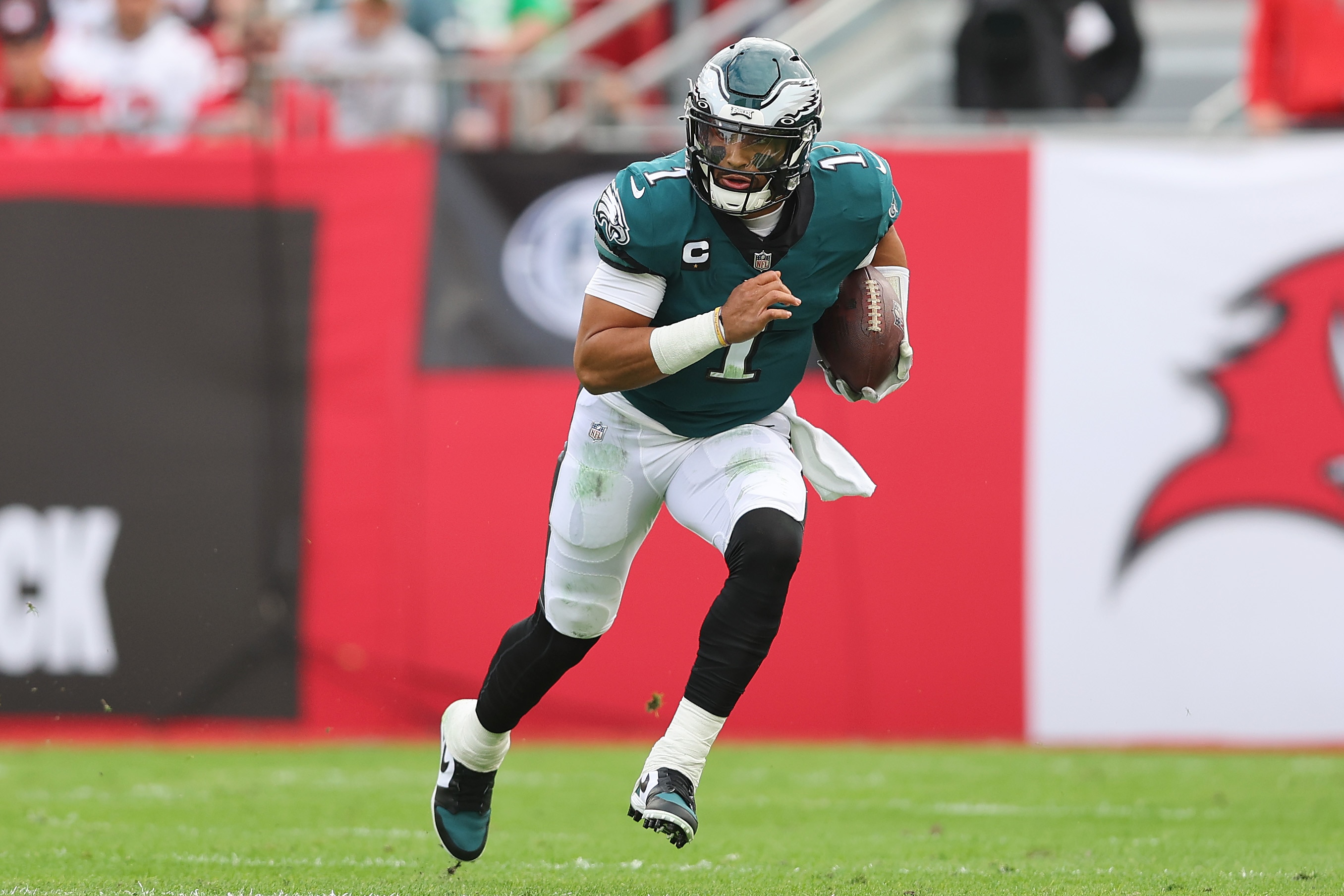 TAMPA, FLORIDA - JANUARY 16: Jalen Hurts #1 of the Philadelphia Eagles runs with the ball against the Tampa Bay Buccaneers in the first half of the NFC Wild Card Playoff game at Raymond James Stadium on January 16, 2022 in Tampa, Florida.  (Photo by Michael Reaves/Getty Images)