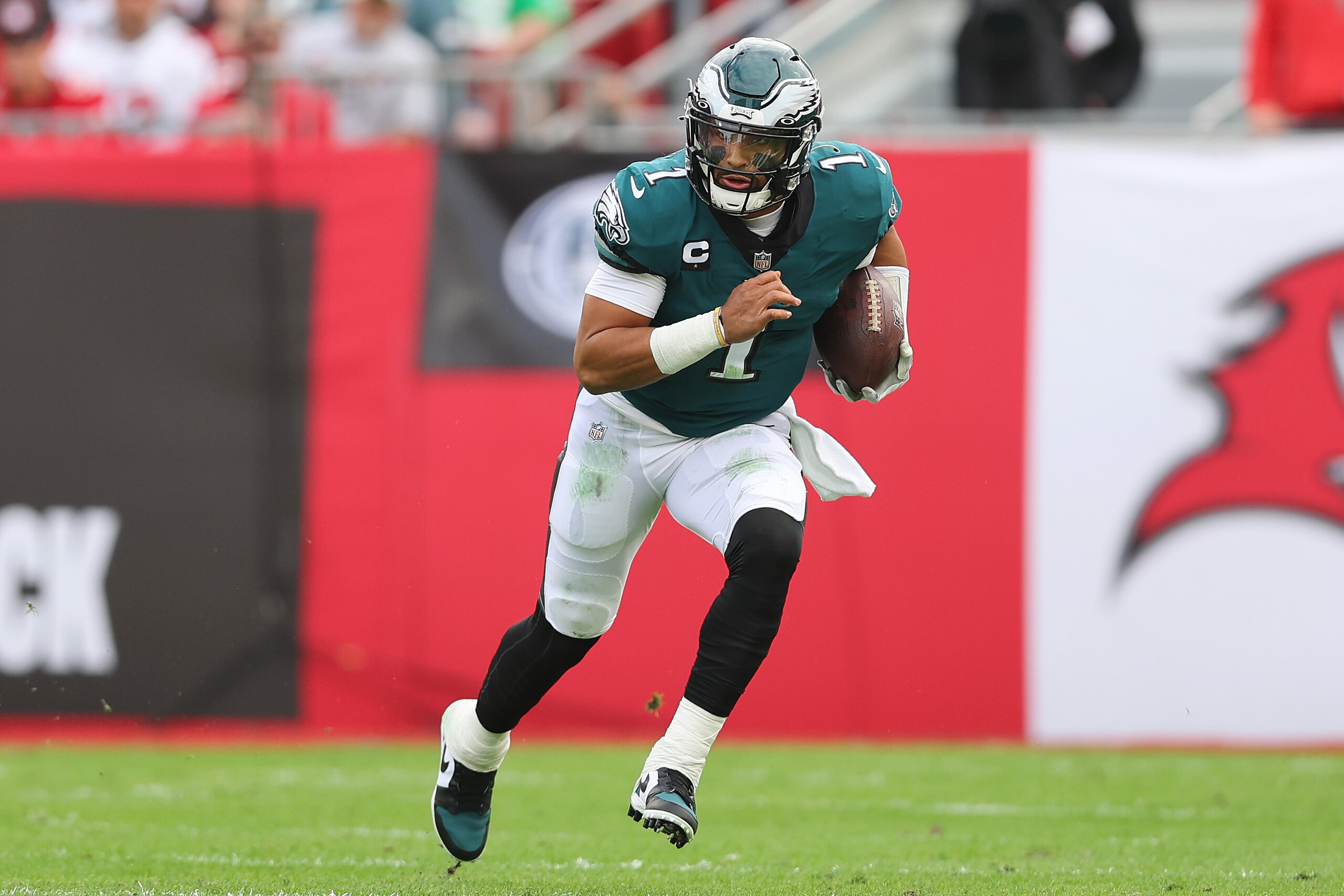 TAMPA, FLORIDA - JANUARY 16: Jalen Hurts #1 of the Philadelphia Eagles runs with the ball against the Tampa Bay Buccaneers in the first half of the NFC Wild Card Playoff game at Raymond James Stadium on January 16, 2022 in Tampa, Florida.  (Photo by Michael Reaves/Getty Images)