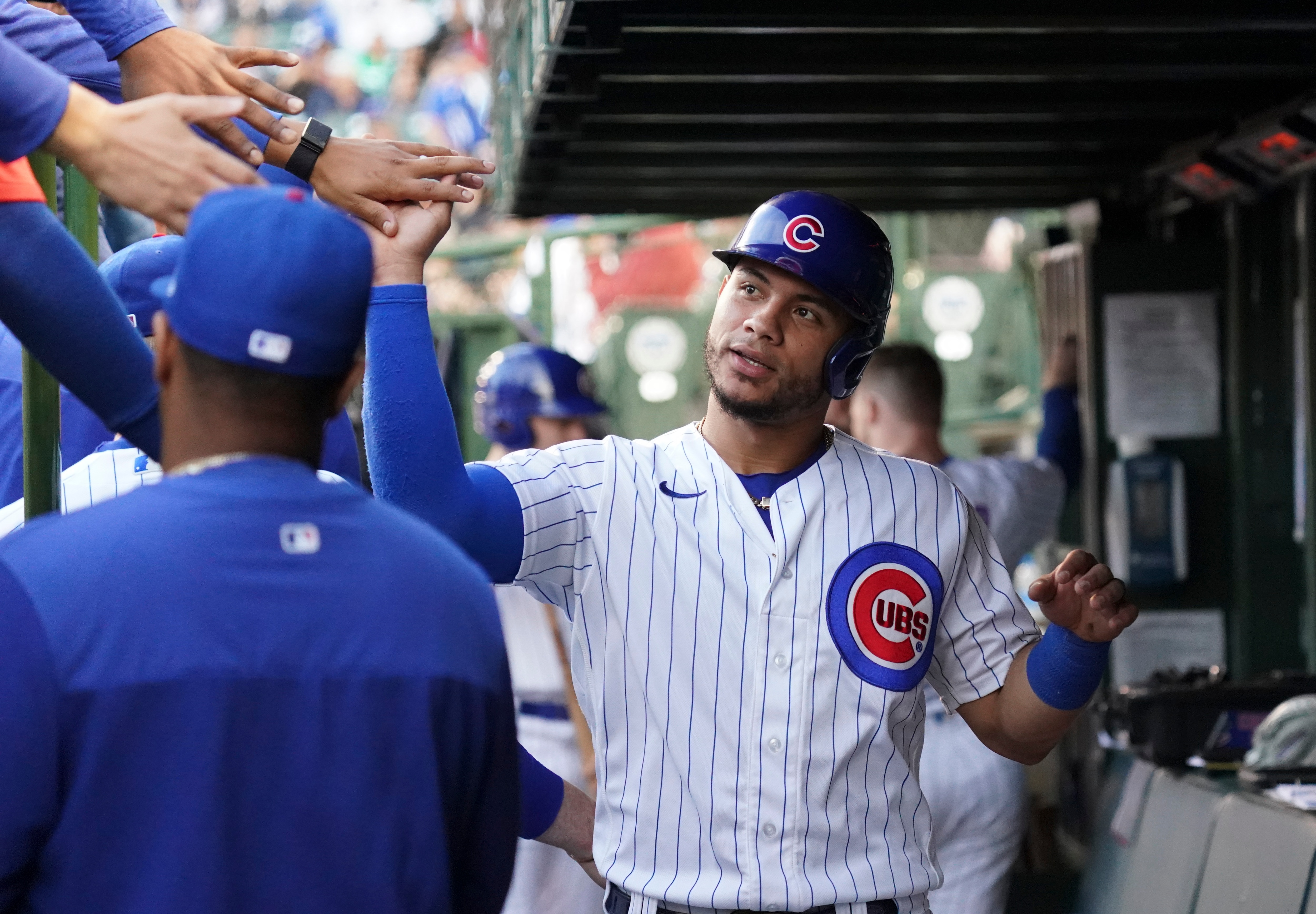 CHICAGO, ILLINOIS - JUNE 01: Willson Contreras #40 of the Chicago Cubs is congratulated by teammates after scoring during the first inning of a game against the Milwaukee Brewers at Wrigley Field on June 01, 2022 in Chicago, Illinois. (Photo by Nuccio DiNuzzo/Getty Images)