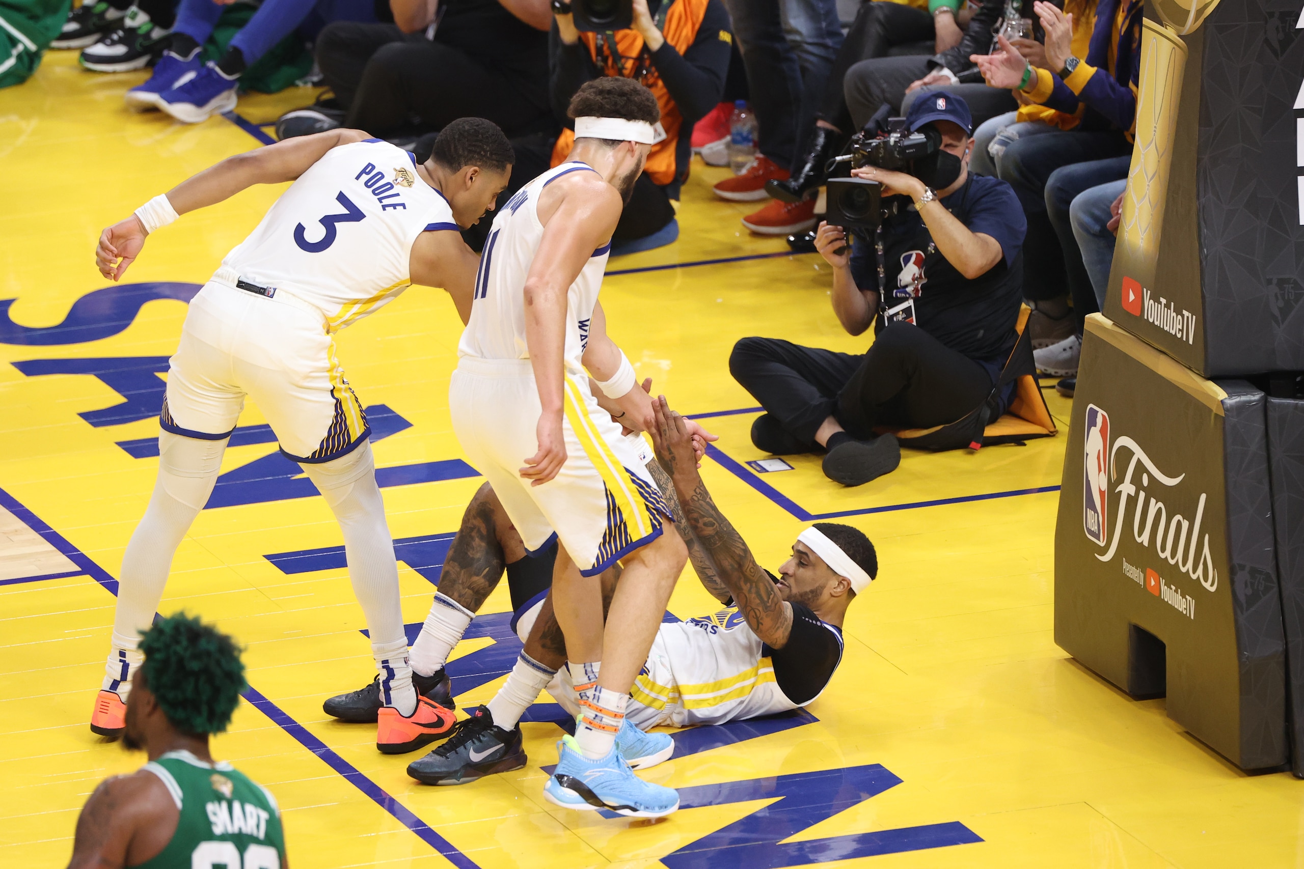 SAN FRANCISCO, CA - JUNE 5: Jordan Poole #3 and Klay Thompson #11 help Gary Payton II #0 of the Golden State Warriors during Game Two of the 2022 NBA Finals on June 5, 2022 at Chase Center in San Francisco, California. NOTE TO USER: User expressly acknowledges and agrees that, by downloading and or using this photograph, user is consenting to the terms and conditions of Getty Images License Agreement. Mandatory Copyright Notice: Copyright 2022 NBAE (Photo by Joe Murphy/NBAE via Getty Images)