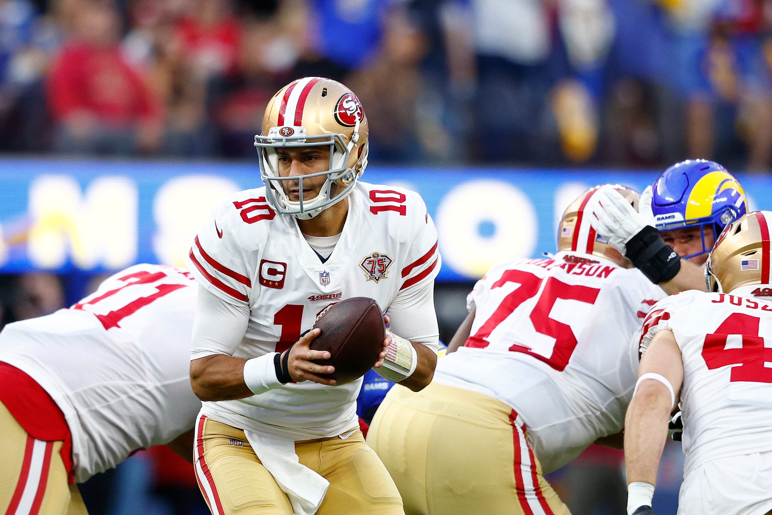INGLEWOOD, CALIFORNIA - JANUARY 30: Jimmy Garoppolo #10 of the San Francisco 49ers looks to hand off the ball to a teammate during the game against the Los Angeles Rams in the NFC Championship Game at SoFi Stadium on January 30, 2022 in Inglewood, California. (Photo by Ronald Martinez/Getty Images)