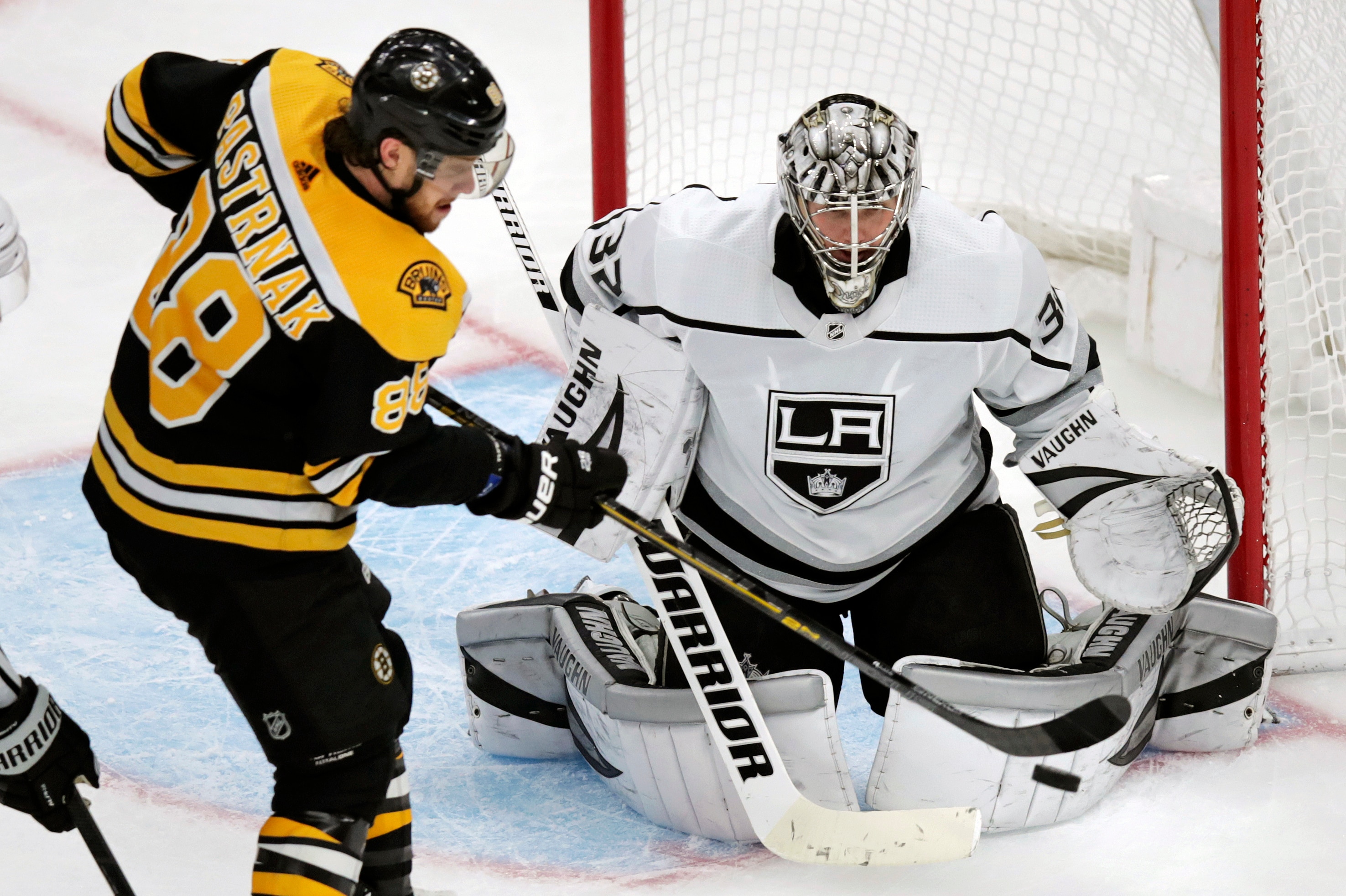 Boston Bruins right wing David Pastrnak (88) tries to tip the puck down in front of Los Angeles Kings goaltender Jonathan Quick during the third period of an NHL hockey game in Boston, Tuesday, Dec. 17, 2019. The Kings won 4-3 in overtime. (AP Photo/Charles Krupa)