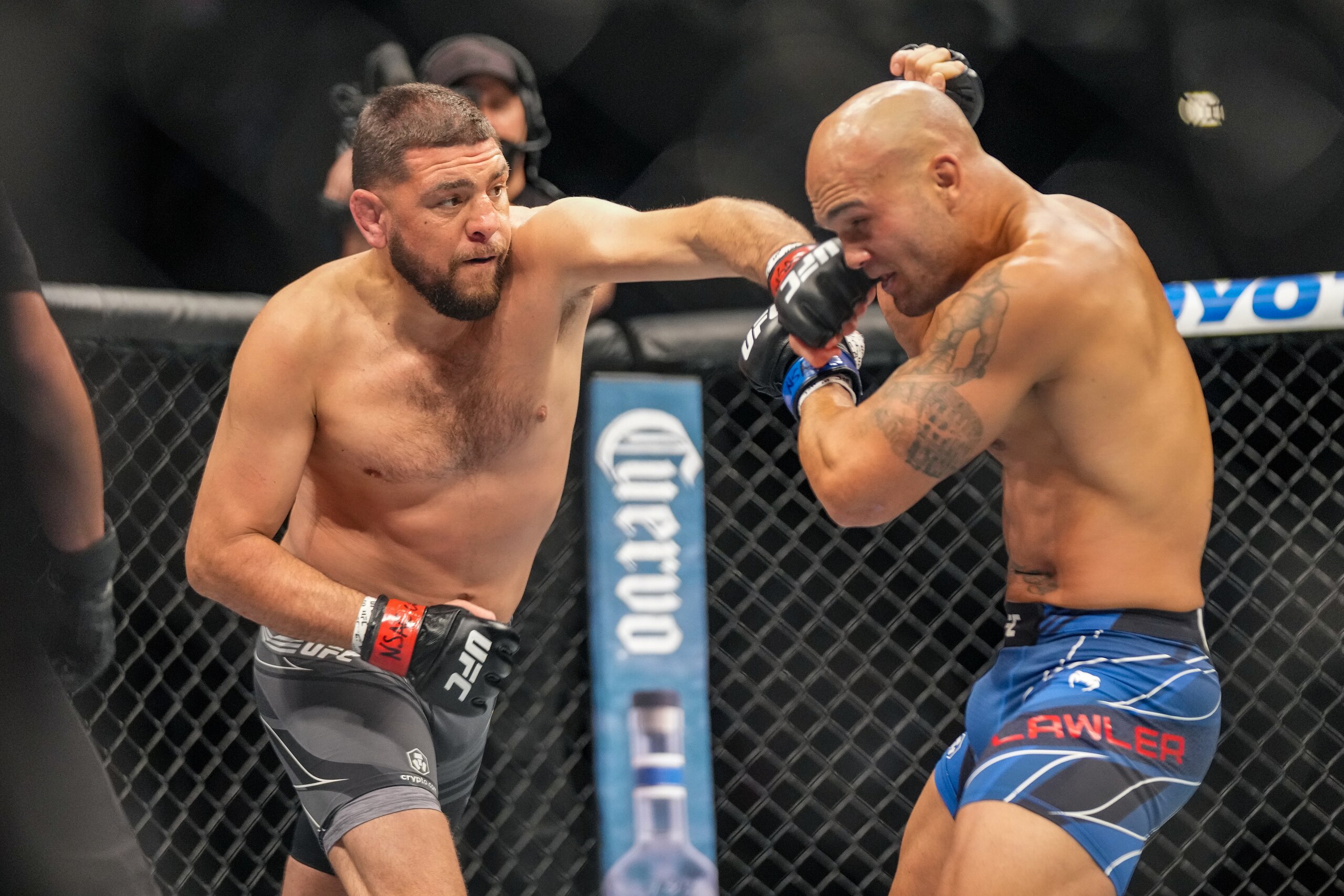 LAS VEGAS, NV - SEPTEMBER 25: (L-R) Nick Diaz punches Robbie Lawler in their middleweight fight during UFC 266 on September 25, 2021, at T-Mobile Arena in Las Vegas, NV. (Photo by Louis Grasse/PxImages/Icon Sportswire via Getty Images)