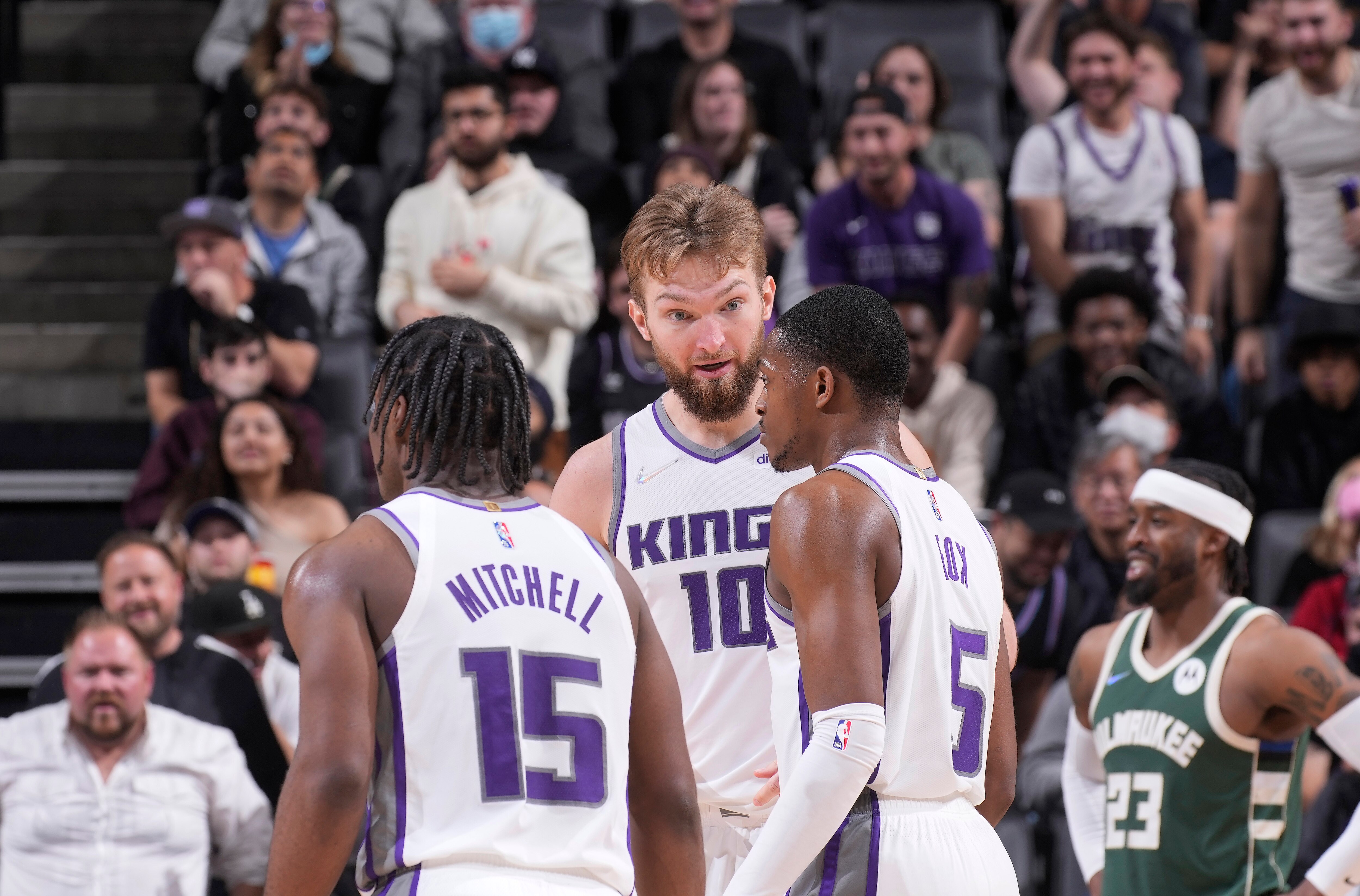 SACRAMENTO, CA - MARCH 16: Domantas Sabonis #10 of the Sacramento Kings talks to teammates Davion Mitchell #15 and De'Aaron Fox #5 during the game against the Milwaukee Bucks on March 16, 2022 at Golden 1 Center in Sacramento, California. NOTE TO USER: User expressly acknowledges and agrees that, by downloading and or using this photograph, User is consenting to the terms and conditions of the Getty Images Agreement. Mandatory Copyright Notice: Copyright 2022 NBAE (Photo by Rocky Widner/NBAE via Getty Images)