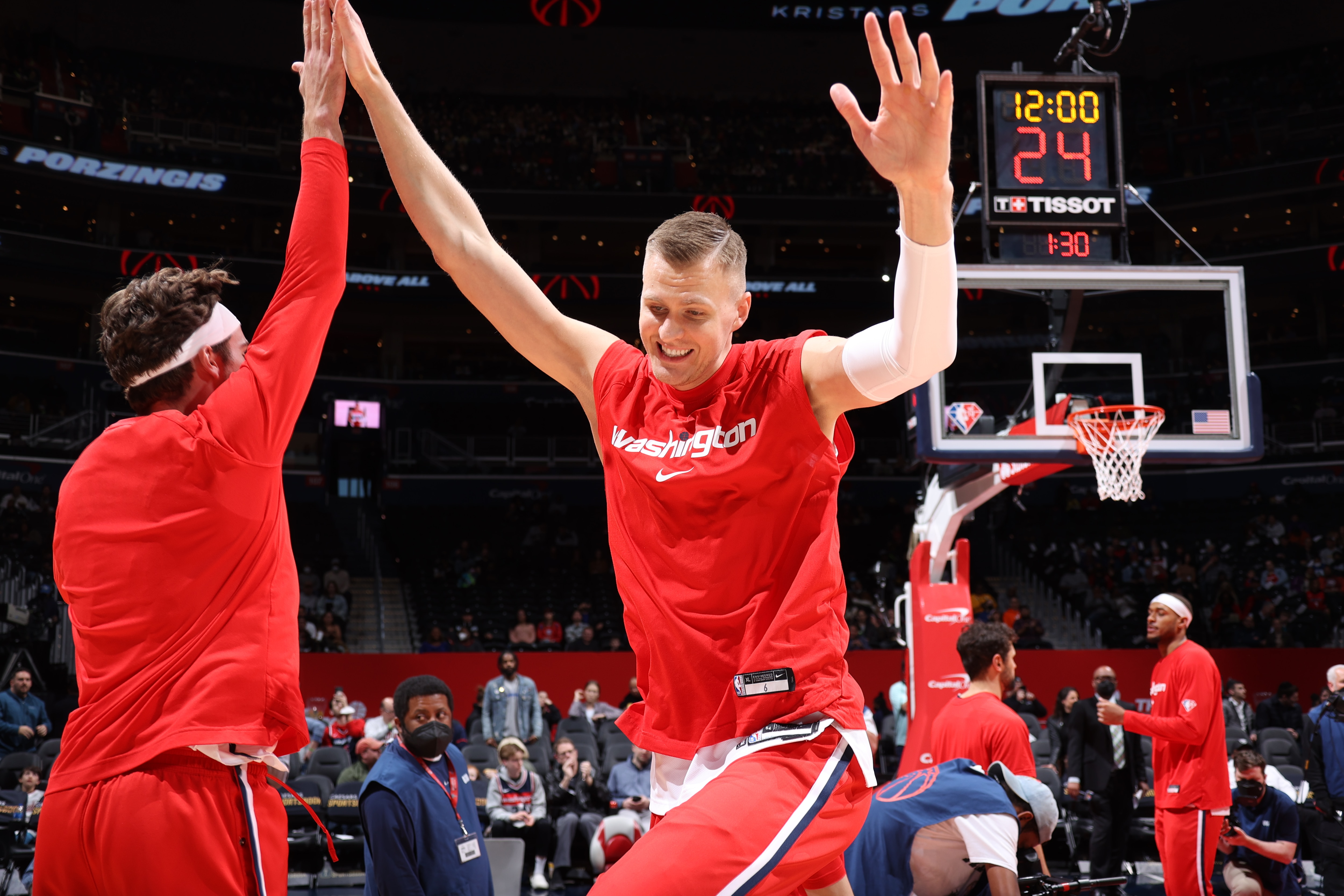 WASHINGTON, DC -  MARCH 30: Kristaps Porzingis #6 of the Washington Wizards high fives Corey Kispert #24 of the Washington Wizards prior to the game against the Orlando Magic on March 30, 2022 at Capital One Arena in Washington, DC. NOTE TO USER: User expressly acknowledges and agrees that, by downloading and or using this Photograph, user is consenting to the terms and conditions of the Getty Images License Agreement. Mandatory Copyright Notice: Copyright 2022 NBAE (Photo by Stephen Gosling/NBAE via Getty Images)