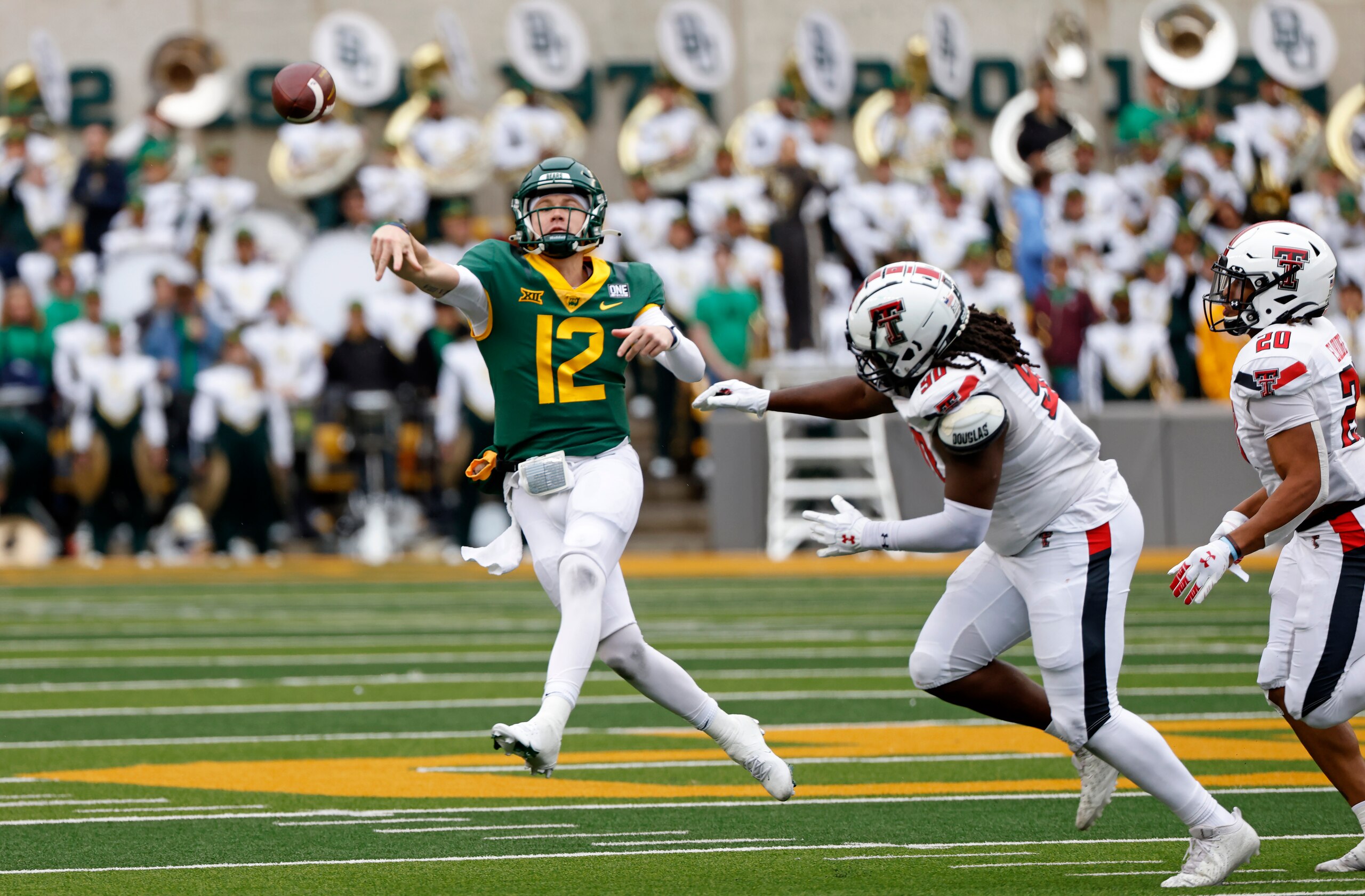 WACO, TX -NOVEMBER 27: Blake Shapen #12 of the Baylor Bears throws a pass under pressure from Devin Drew #90 of the Texas Tech Red Raiders in the second half at McLane Stadium on November 27, 2021 in Waco, Texas. Baylor won 27-24. (Photo by Ron Jenkins/Getty Images)