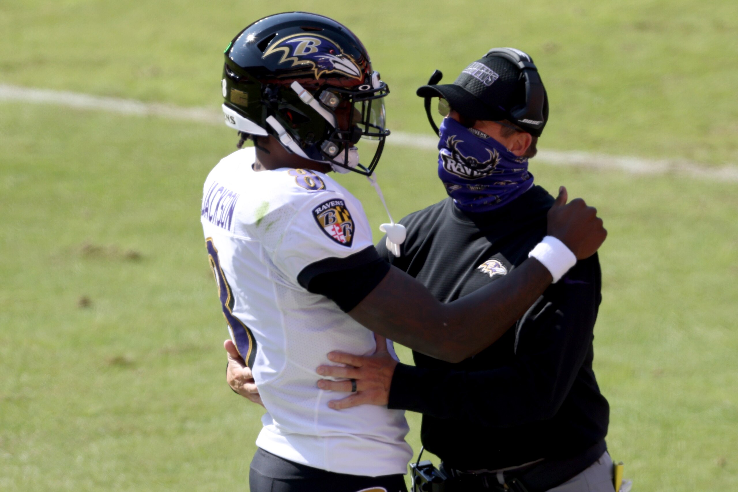 LANDOVER, MARYLAND - OCTOBER 04: Quarterback Lamar Jackson #8 of the Baltimore Ravens celebrates with head coach John Harbaugh after rushing for a second quarter touchdown against the Washington Football Team at FedExField on October 04, 2020 in Landover, Maryland. (Photo by Rob Carr/Getty Images)