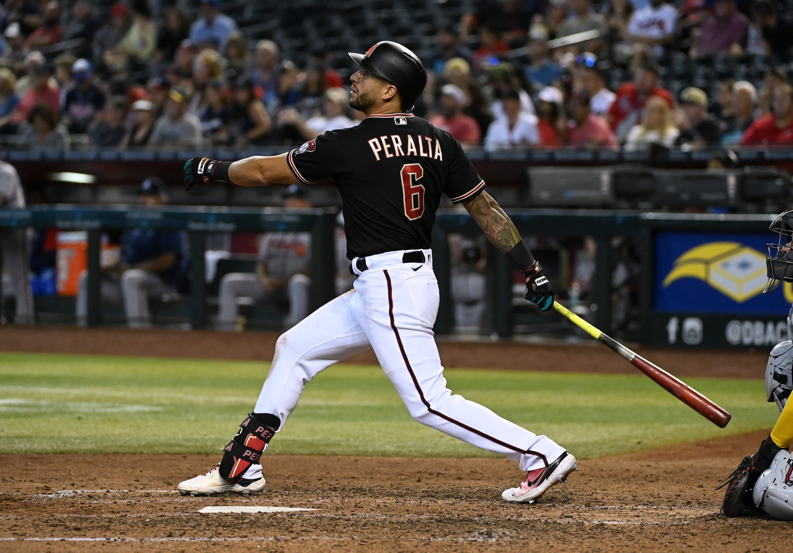 PHOENIX, ARIZONA - JUNE 01: David Peralta #6 of the Arizona Diamondbacks follows through on a swing against the Atlanta Braves at Chase Field on June 01, 2022 in Phoenix, Arizona. (Photo by Norm Hall/Getty Images)