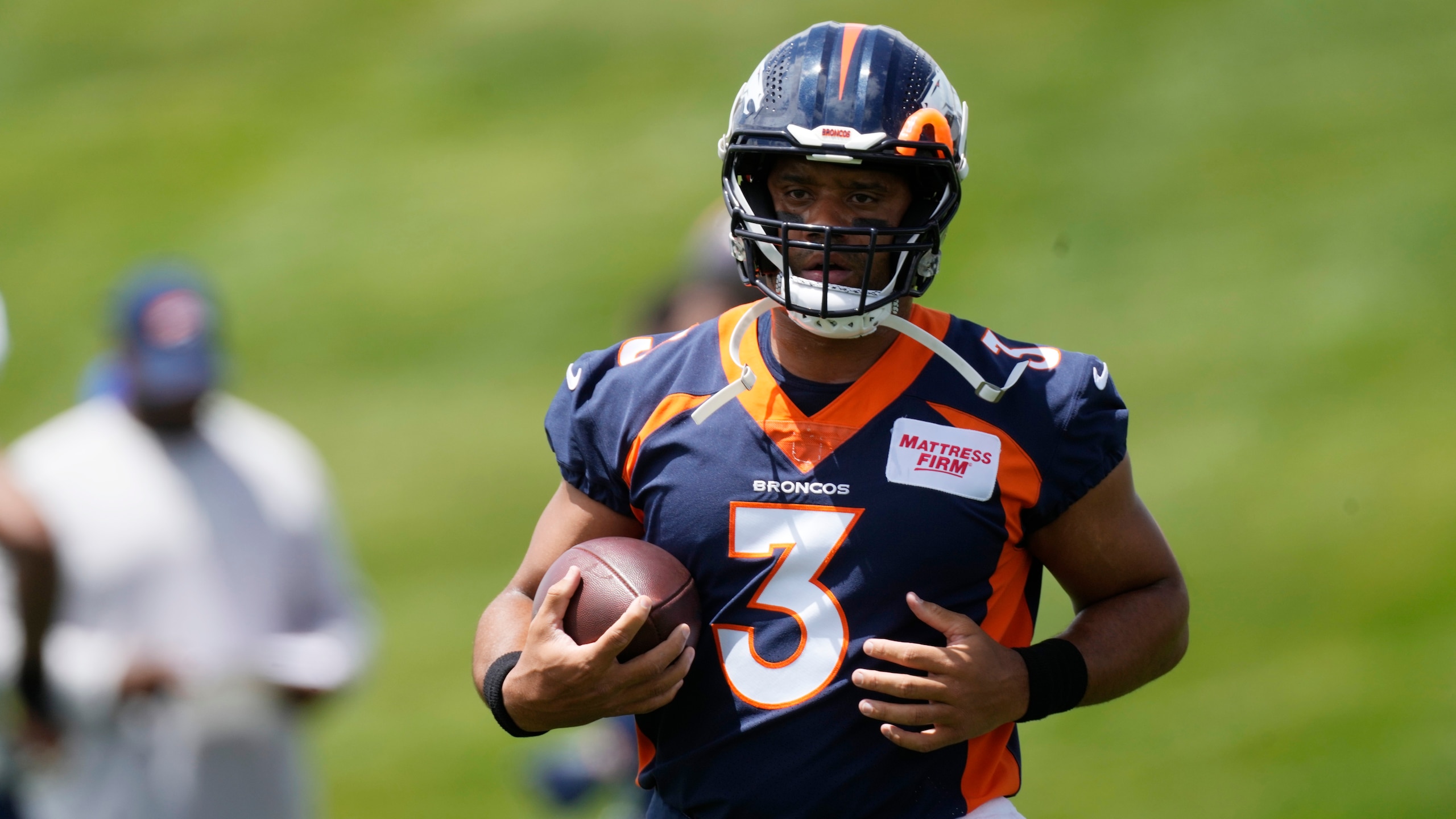 Denver Broncos quarterback Russell Wilson takes part in drills at the NFL football team's headquarters Monday, June 6, 2022, in Centennial, Colo. (AP Photo/David Zalubowski)