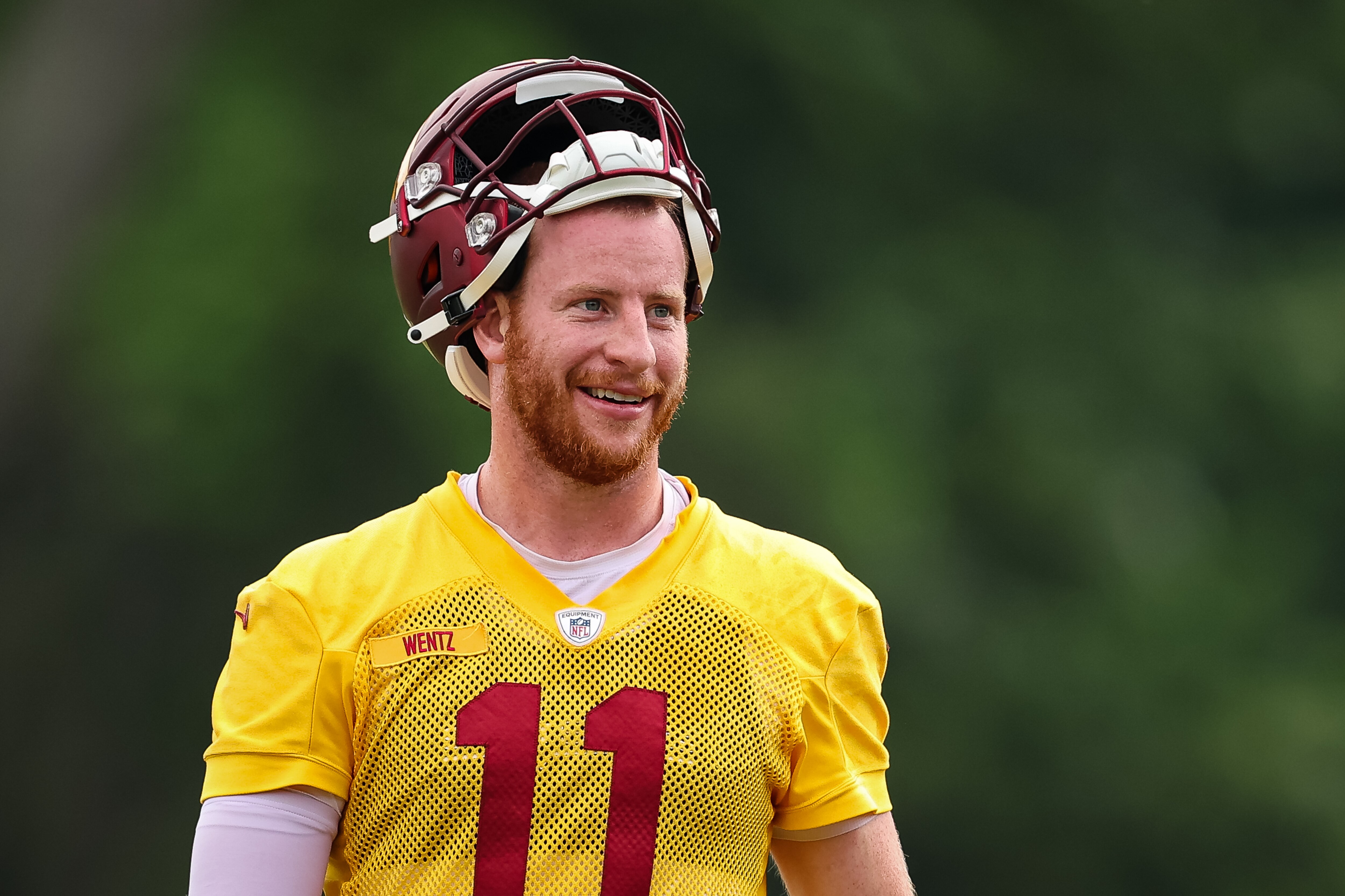 ASHBURN, VA - JUNE 08: Carson Wentz #11 of the Washington Commanders reacts during the organized team activity at INOVA Sports Performance Center on June 8, 2022 in Ashburn, Virginia. (Photo by Scott Taetsch/Getty Images)