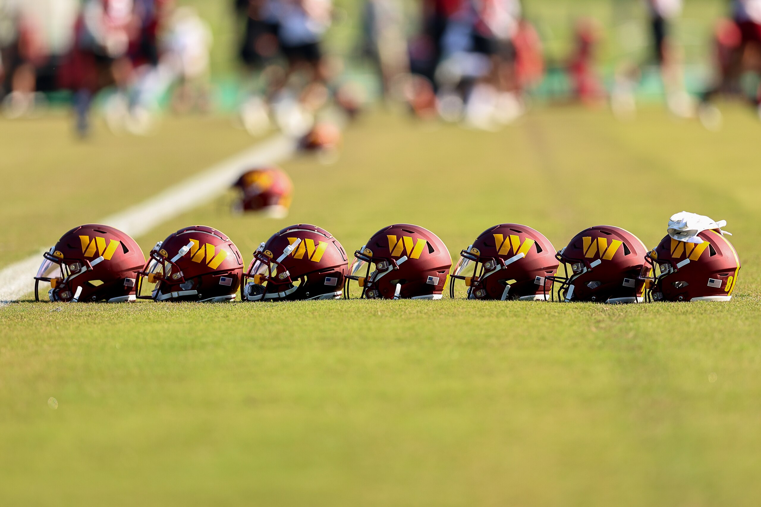 LOUDOUN COUNTY, VA - JUNE 01: Players helmets are placed on the field during the Washington Commanders OTA on June 1, 2022 at the Park in Ashburn, Virginia. (Photo by John McCreary/Icon Sportswire via Getty Images) LOUDOUN COUNTY, VA - JUNE 01: Players helmets are placed on the field during the Washington Commanders OTA on June 1, 2022 at the Park in Ashburn, Virginia. (Photo by John McCreary/Icon Sportswire via Getty Images)