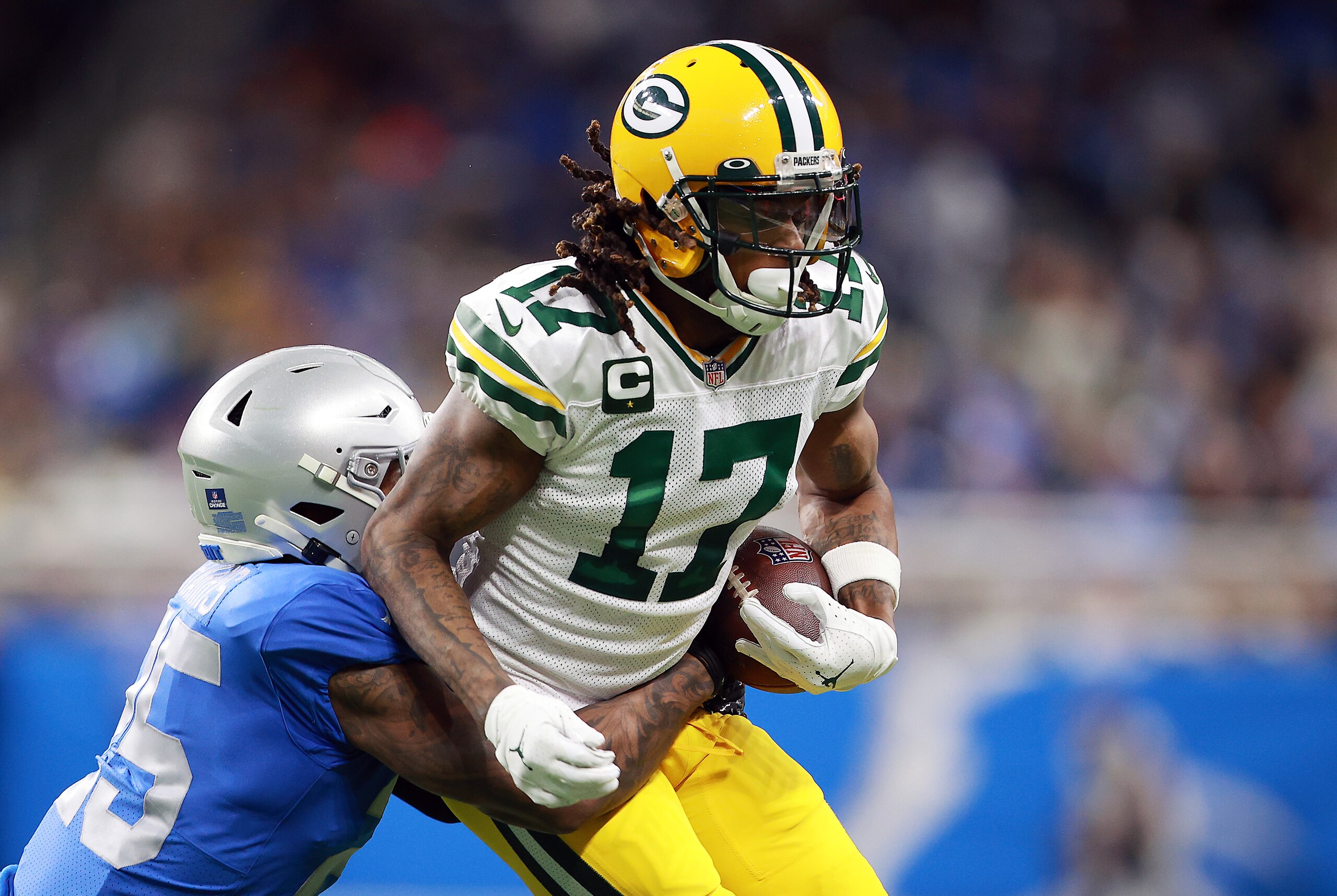 DETROIT, MICHIGAN - JANUARY 09: Davante Adams #17 of the Green Bay Packers carries the ball after a reception during the first half against the Detroit Lions at Ford Field on January 09, 2022 in Detroit, Michigan. (Photo by Rey Del Rio/Getty Images)