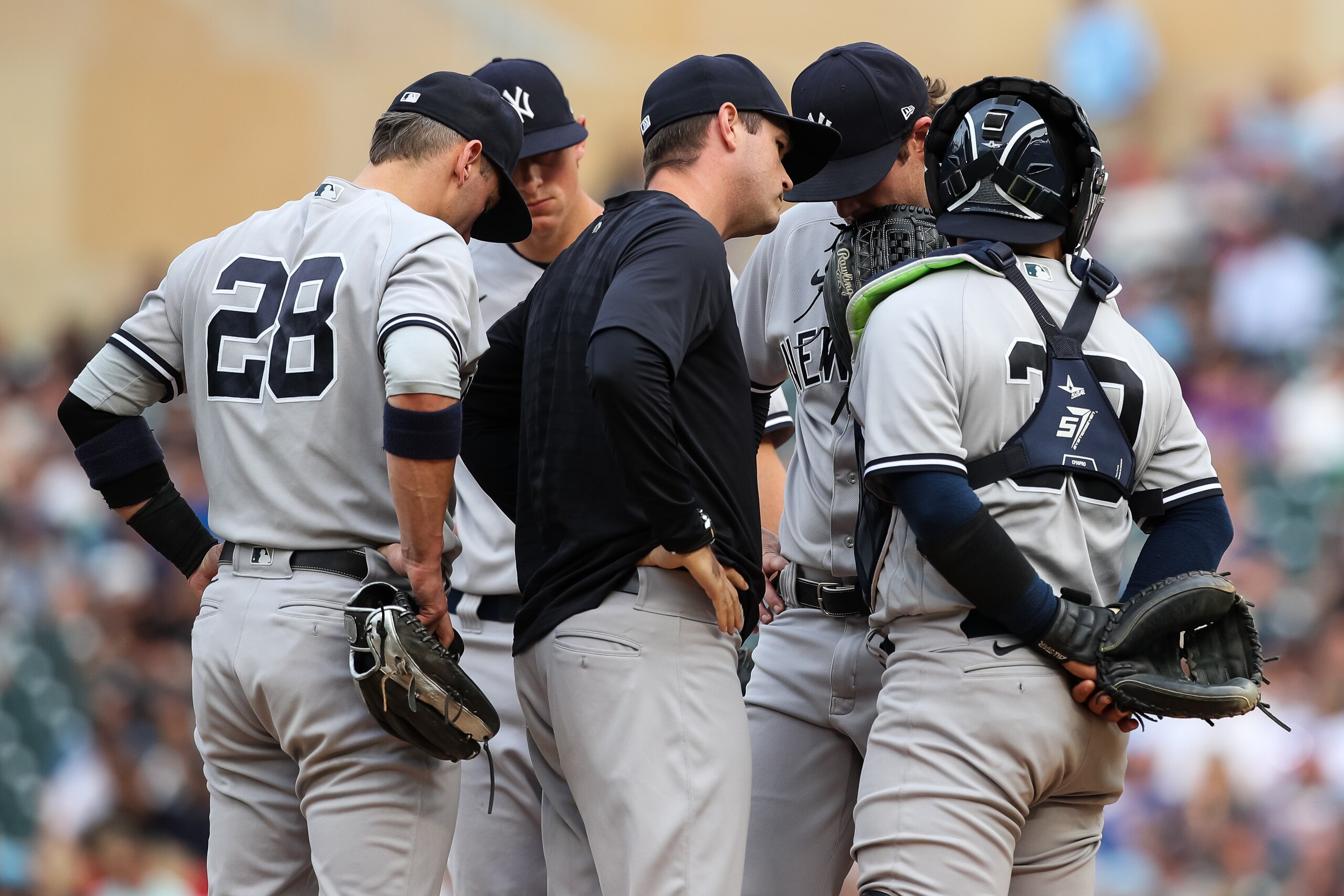 MINNEAPOLIS, MN - JUNE 09: Matt Blake #77 of the New York Yankees talks to Gerrit Cole #45 and the rest of the infield during a mound visit after Cole gave up three solo home runs in a row against the Minnesota Twins in the first inning of the game at Target Field on June 9, 2022 in Minneapolis, Minnesota. (Photo by David Berding/Getty Images)