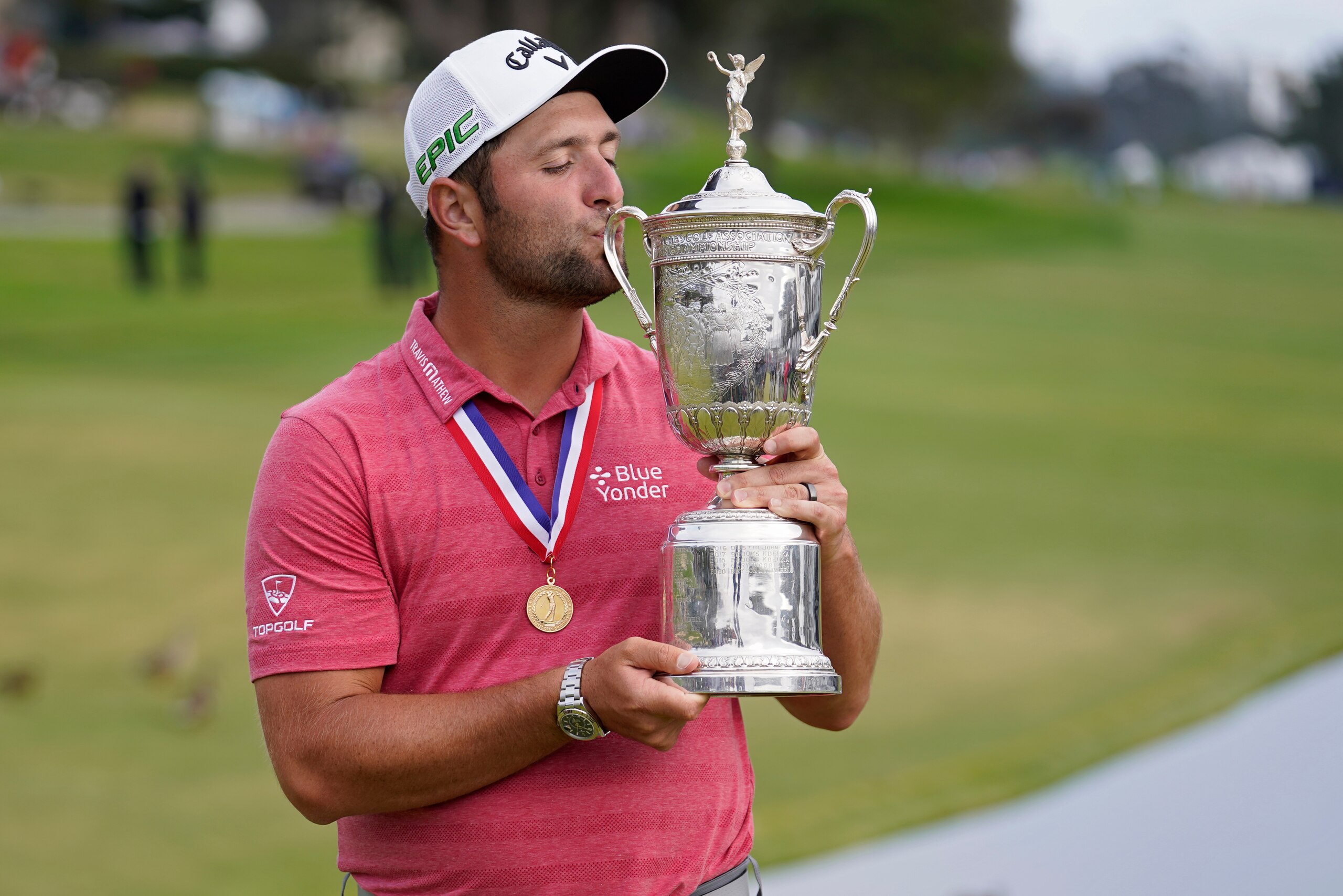 FILE - Jon Rahm, of Spain, kisses the champions trophy for photographers after the final round of the U.S. Open Golf Championship, Sunday, June 20, 2021, at Torrey Pines Golf Course in San Diego. Golf has been moving toward youth for some time now, and the recent majors are an example. The last four major champions are in their 20s, dating to defending U.S. Open champion Jon Rahm, who was 26 when he won at Torrey Pines last year. (AP Photo/Marcio Jose Sanchez, File)