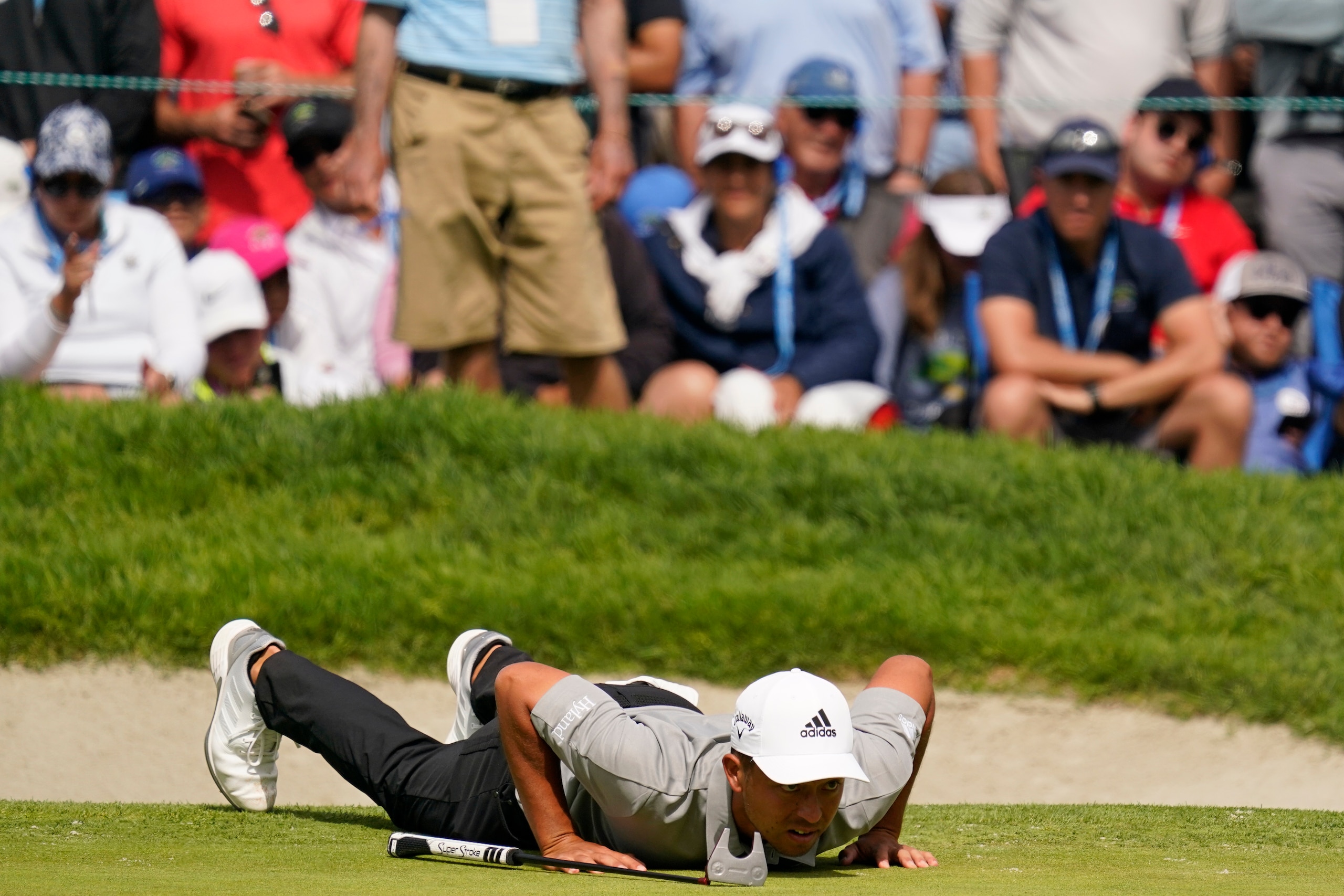 Xander Schauffele lines up his shot on the 18th green during the final round of the U.S. Open Golf Championship, Sunday, June 20, 2021, at Torrey Pines Golf Course in San Diego. (AP Photo/Gregory Bull)