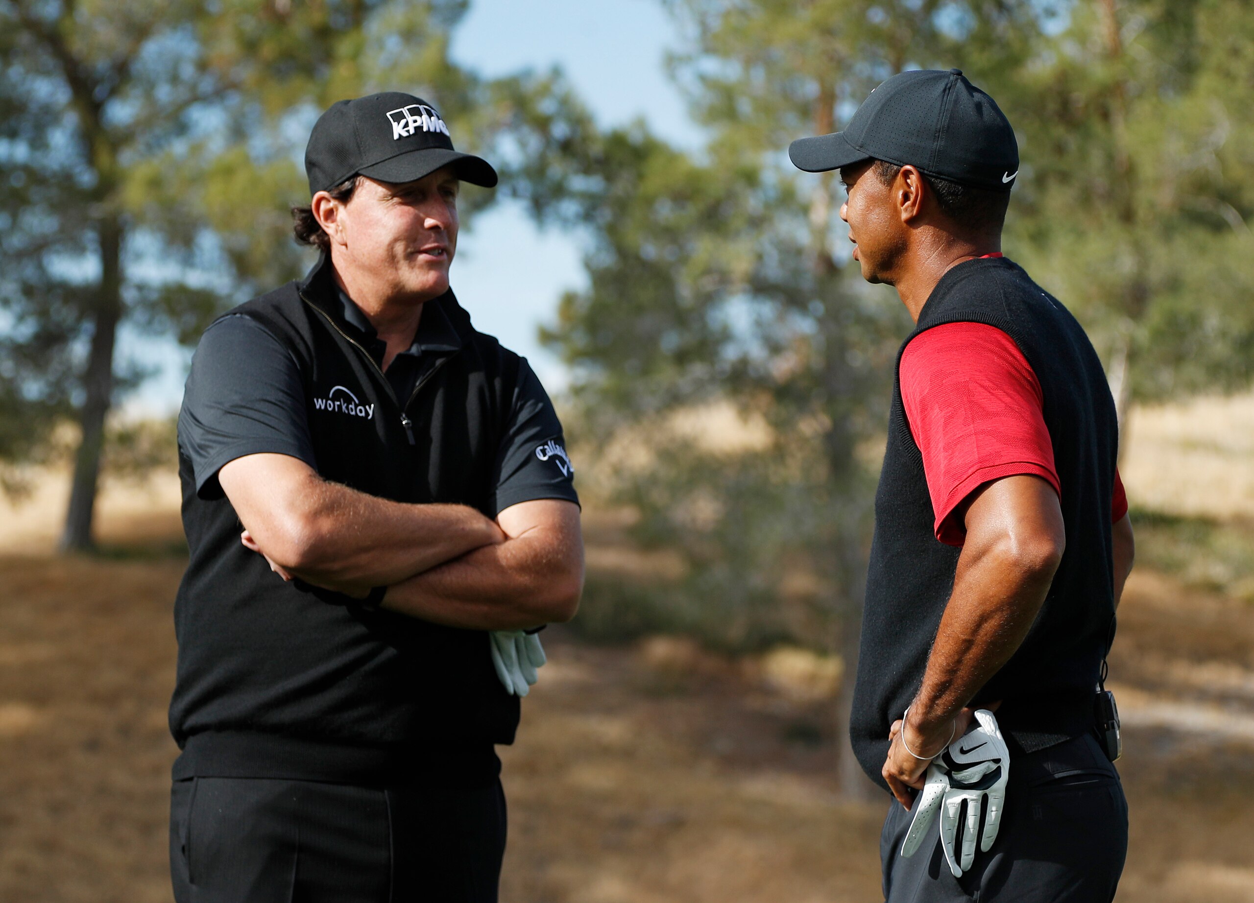 Phil Mickelson, left, and Tiger Woods talk at the first tee before a golf match at Shadow Creek golf course, Friday, Nov. 23, 2018, in Las Vegas. (AP Photo/John Locher)