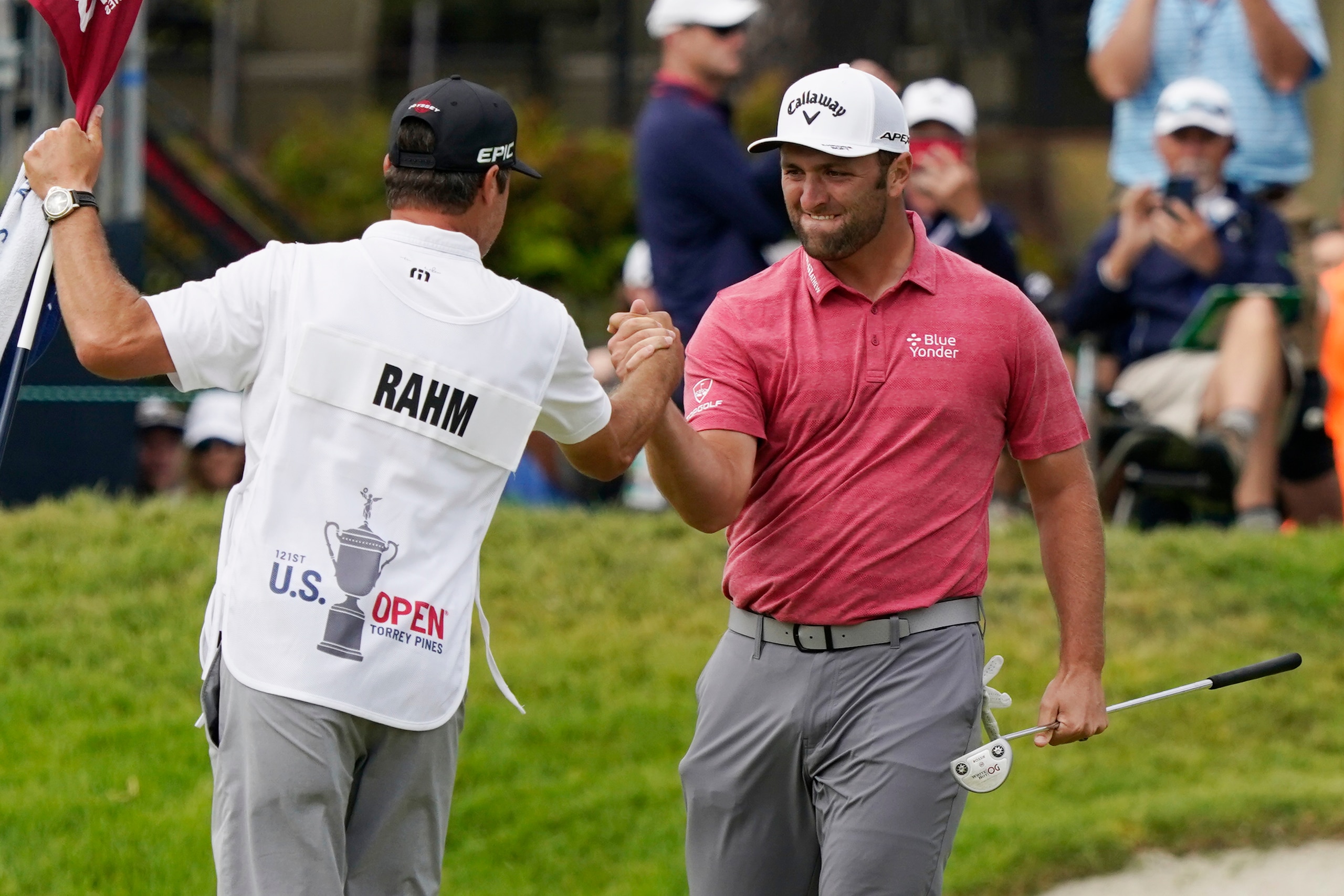 Jon Rahm, of Spain, celebrates with his caddy after making his birdie putt on the 18th green during the final round of the U.S. Open Golf Championship, Sunday, June 20, 2021, at Torrey Pines Golf Course in San Diego. (AP Photo/Marcio Jose Sanchez)