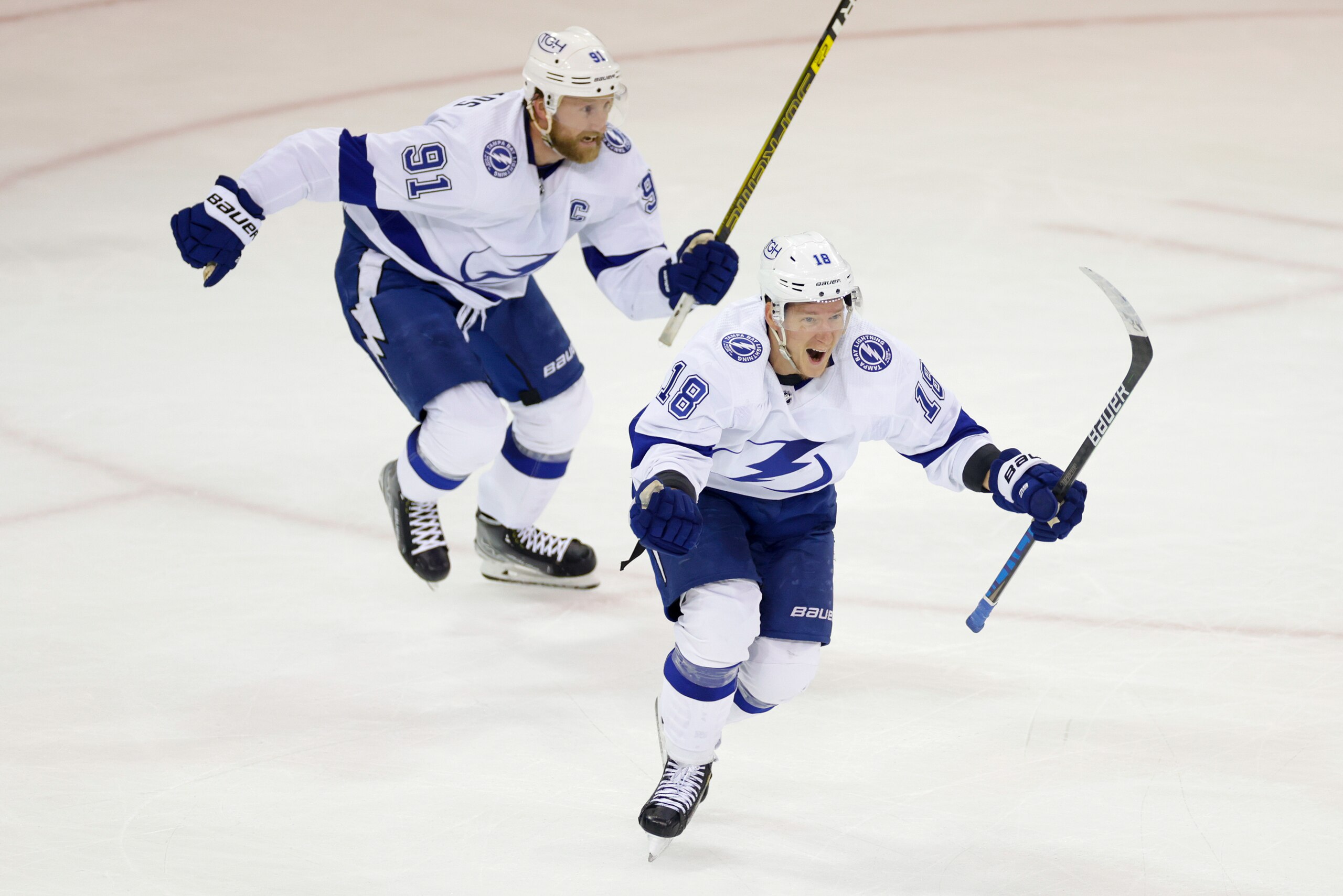 Tampa Bay Lightning left wing Ondrej Palat (18) and center Steven Stamkos (91) react after a goal by defenseman Mikhail Sergachev against the New York Rangers during the third period in Game 5 of the NHL Hockey Stanley Cup playoffs Eastern Conference Finals, Thursday, June 9, 2022, in New York (AP Photo/Adam Hunger)