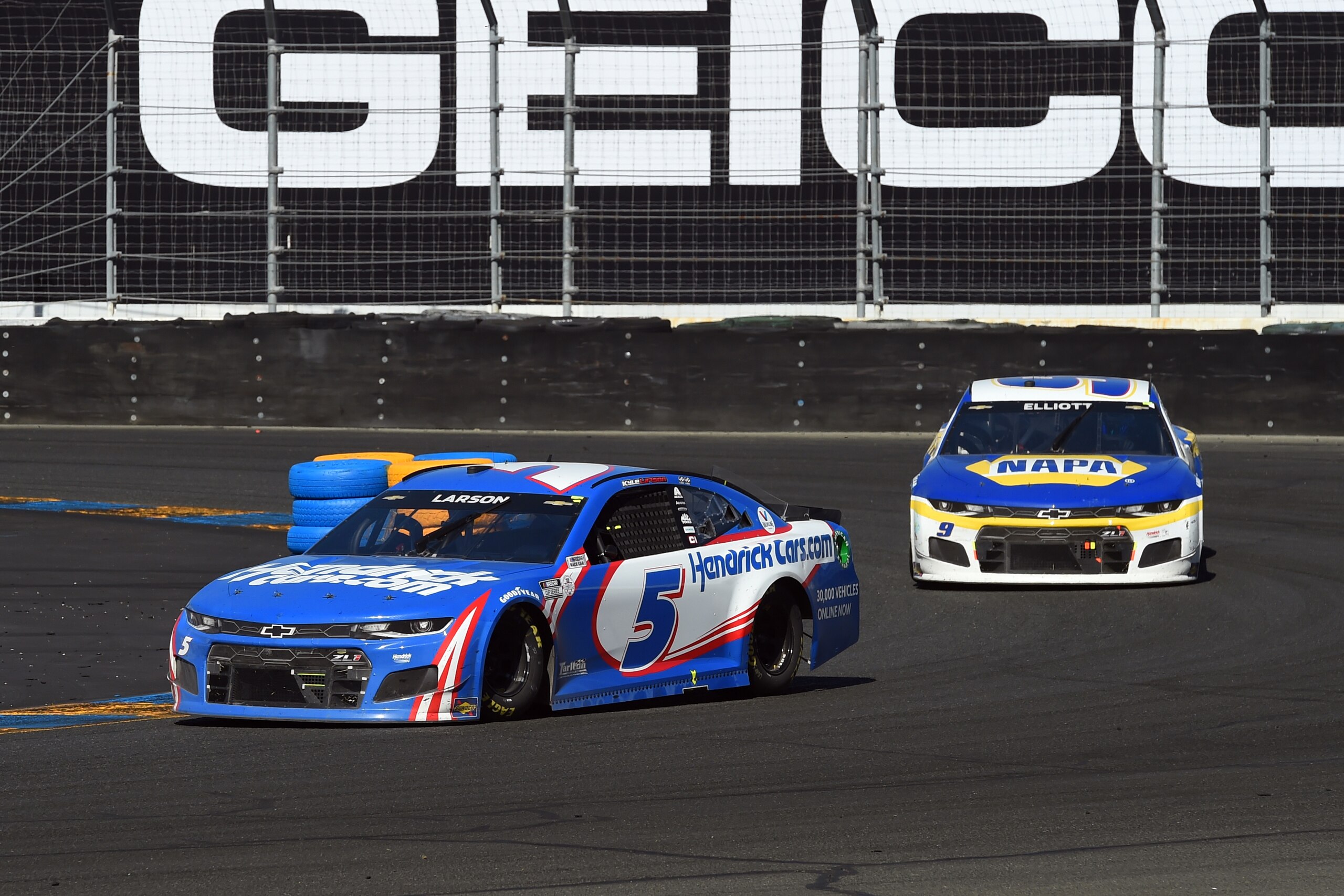SONOMA, CA - JUNE 06: Kyle Larson, driver of the #5 Hendrick Motorsports HendrickCars.com Chevrolet,  leads Chase Elliott, driver of the #9 Hendrick Motorsports NAPA Auto Parts Chevrolet,  through turn 11 during the Toyota/Save Mart 350 NASCAR Cup Series race on June 6, 2021, at Sonoma Raceway in Sonoma, CA. (Photo by Chris Williams/Sonoma Raceway via Icon Sportswire)