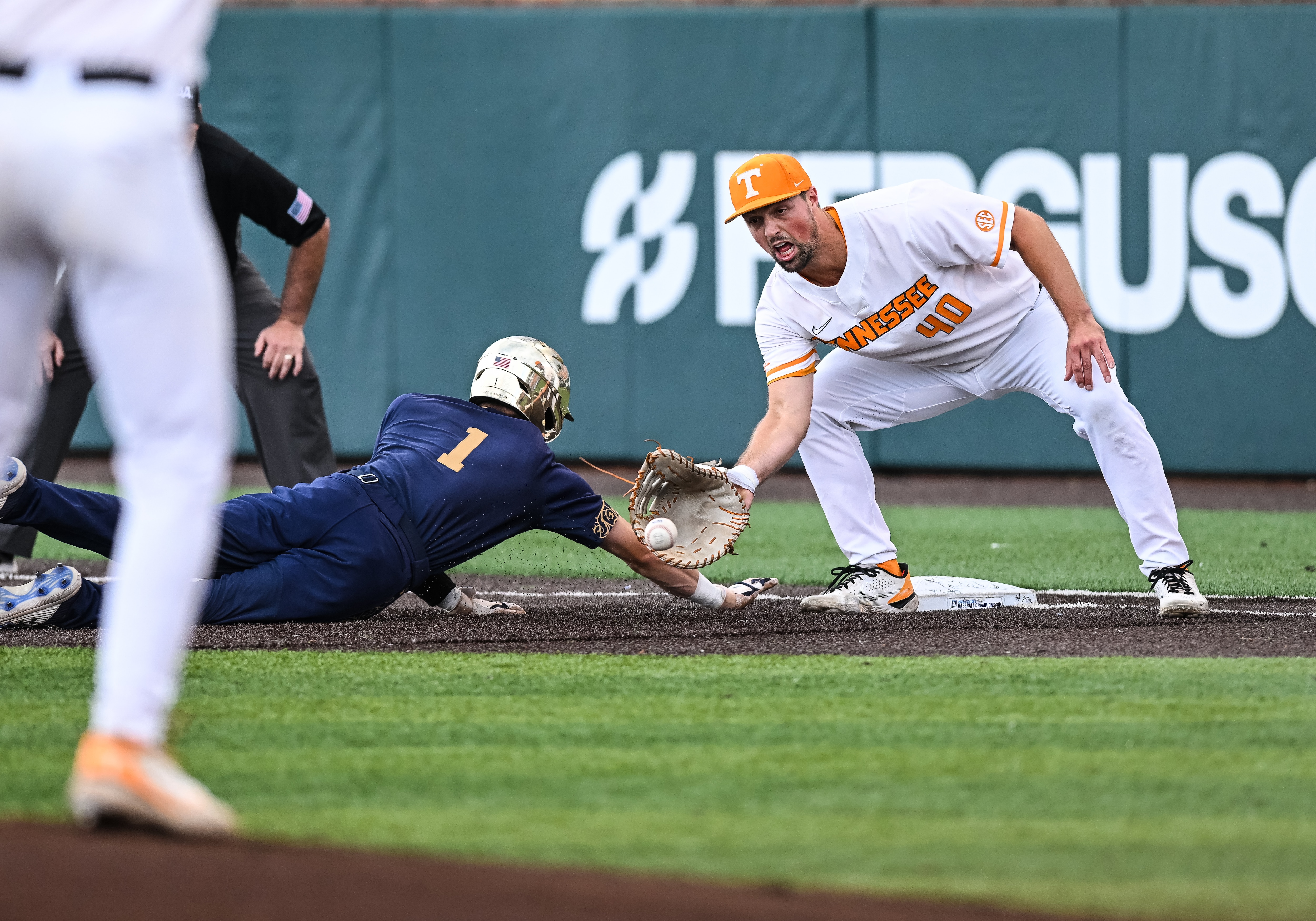 KNOXVILLE, TN - JUNE 10:  Notre Dame outfielder Ryan Cole (1) dives back into first and avoids the tag by Tennessee first baseman Luc Lipcius (40) in game one of the NCAA Super Regionals between the Tennessee Volunteers and Notre Dame Fighting Irish on June 10, 2022, at Lindsey Nelson Stadium in Knoxville, TN. (Photo by Bryan Lynn/Icon Sportswire via Getty Images)