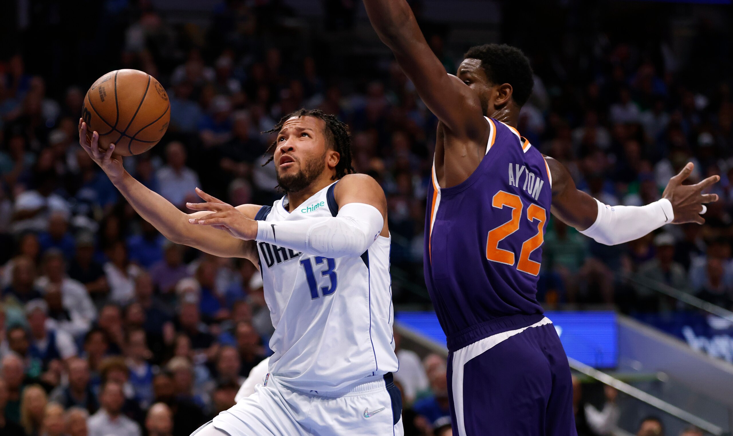 DALLAS, TX - MAY 6: Jalen Brunson #13 of the Dallas Mavericks drives to the basket to score against Deandre Ayton #22 of the Phoenix Suns during the second half of Game Three of the 2022 NBA Playoffs Western Conference Semifinals at American Airlines Center on May 6, 2022 in Dallas, Texas. NOTE TO USER: User expressly acknowledges and agrees that, by downloading and or using this photograph, User is consenting to the terms and conditions of the Getty Images License Agreement. (Photo by Ron Jenkins/Getty Images)