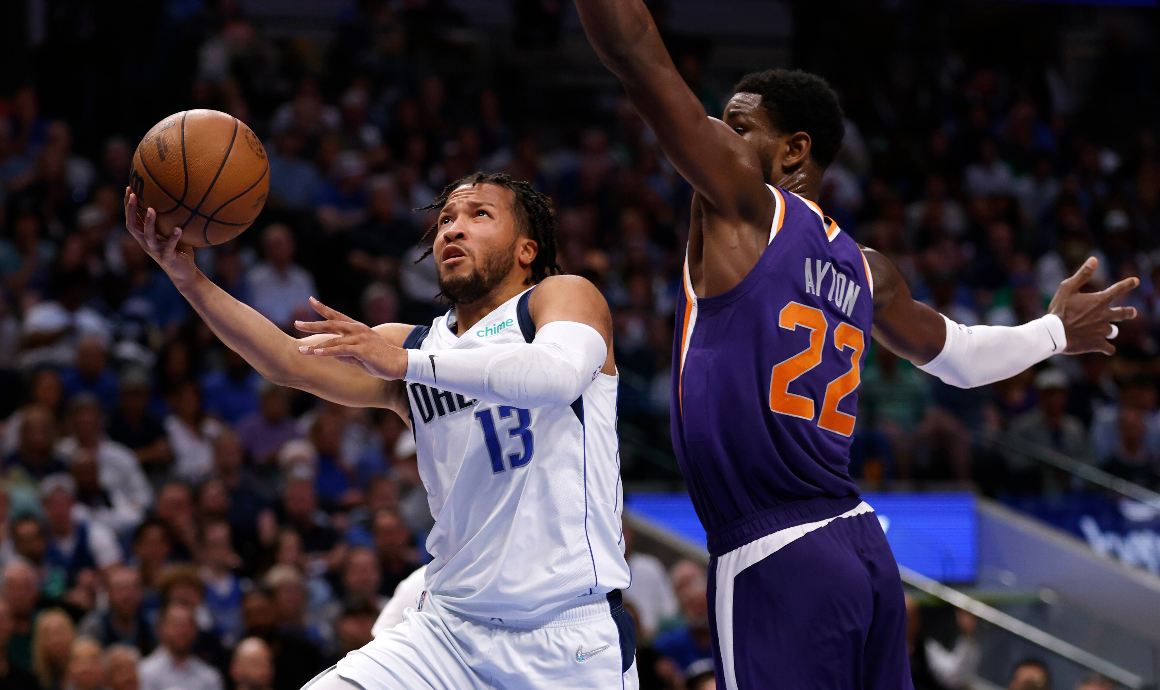 DALLAS, TX - MAY 6: Jalen Brunson #13 of the Dallas Mavericks drives to the basket to score against Deandre Ayton #22 of the Phoenix Suns during the second half of Game Three of the 2022 NBA Playoffs Western Conference Semifinals at American Airlines Center on May 6, 2022 in Dallas, Texas. NOTE TO USER: User expressly acknowledges and agrees that, by downloading and or using this photograph, User is consenting to the terms and conditions of the Getty Images License Agreement. (Photo by Ron Jenkins/Getty Images)