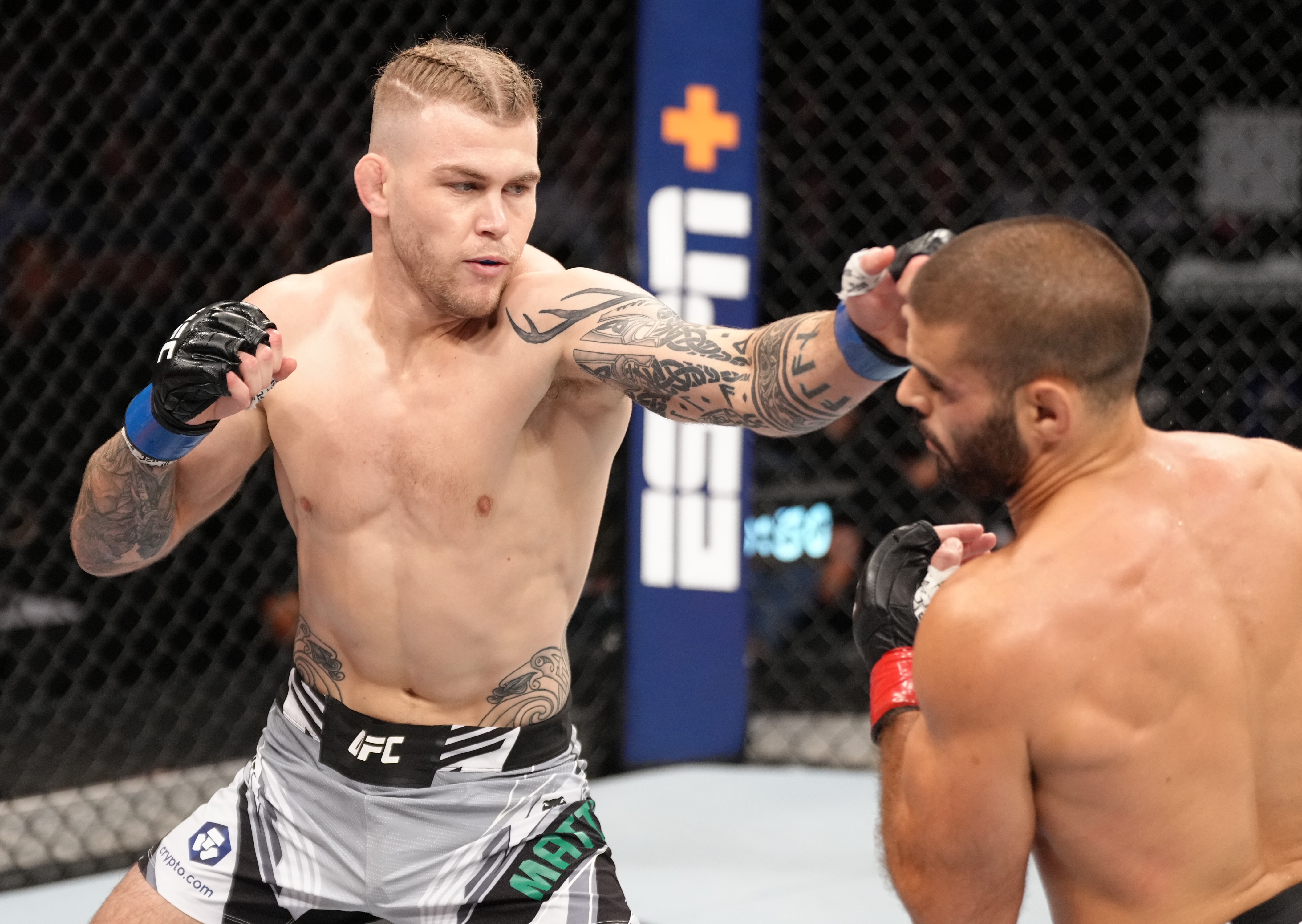 SINGAPORE, SINGAPORE - JUNE 12: (L-R) Jake Matthews of Australia punches Andre Fialho of Portugal in a welterweight fight during the UFC 275 event at Singapore Indoor Stadium on June 12, 2022 in Singapore. (Photo by Jeff Bottari/Zuffa LLC)