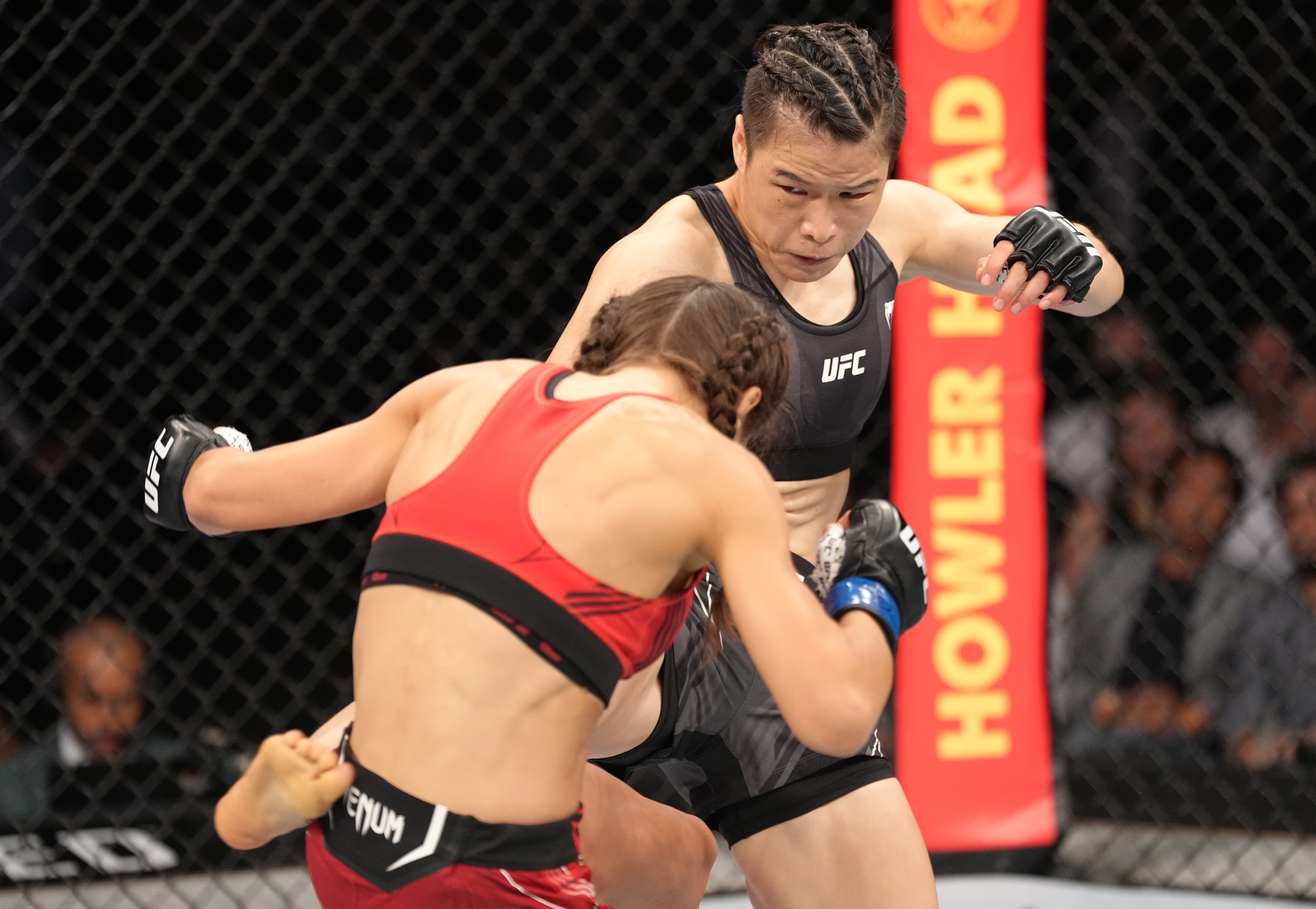 SINGAPORE, SINGAPORE - JUNE 12: (R-L) Zhang Weili of China kicks Joanna Jedrzejczyk of Poland in a flyweight fight during the UFC 275 event at Singapore Indoor Stadium on June 12, 2022 in Singapore. (Photo by Jeff Bottari/Zuffa LLC)