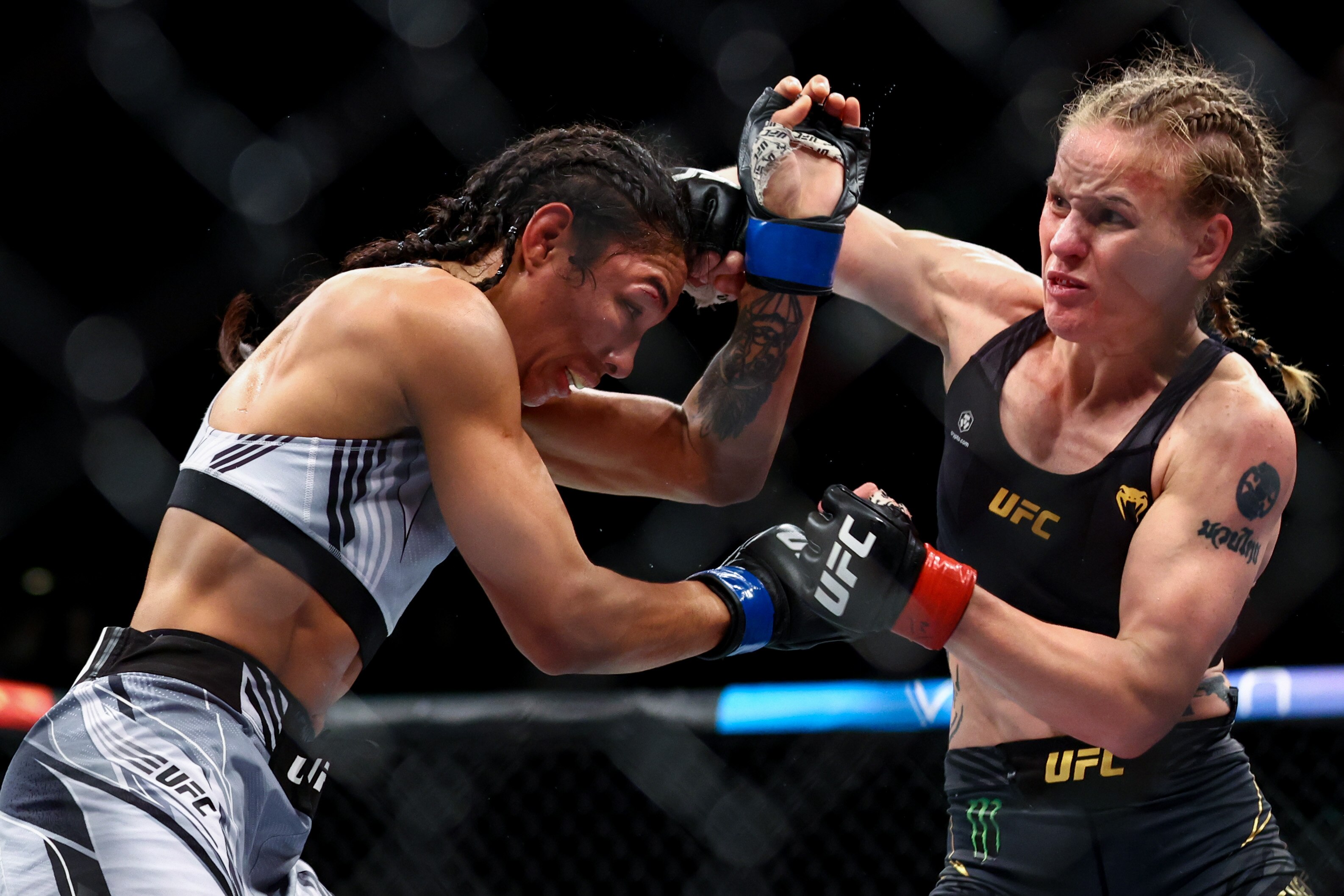 SINGAPORE, SINGAPORE - JUNE 12: Valentina Shevchenko of Kyrgyzstan exchanges strikes with Taila Santos of Brazil during their Women's Flyweight Fight at Singapore Indoor Stadium on June 12, 2022 in Singapore. (Photo by Yong Teck Lim/Getty Images)