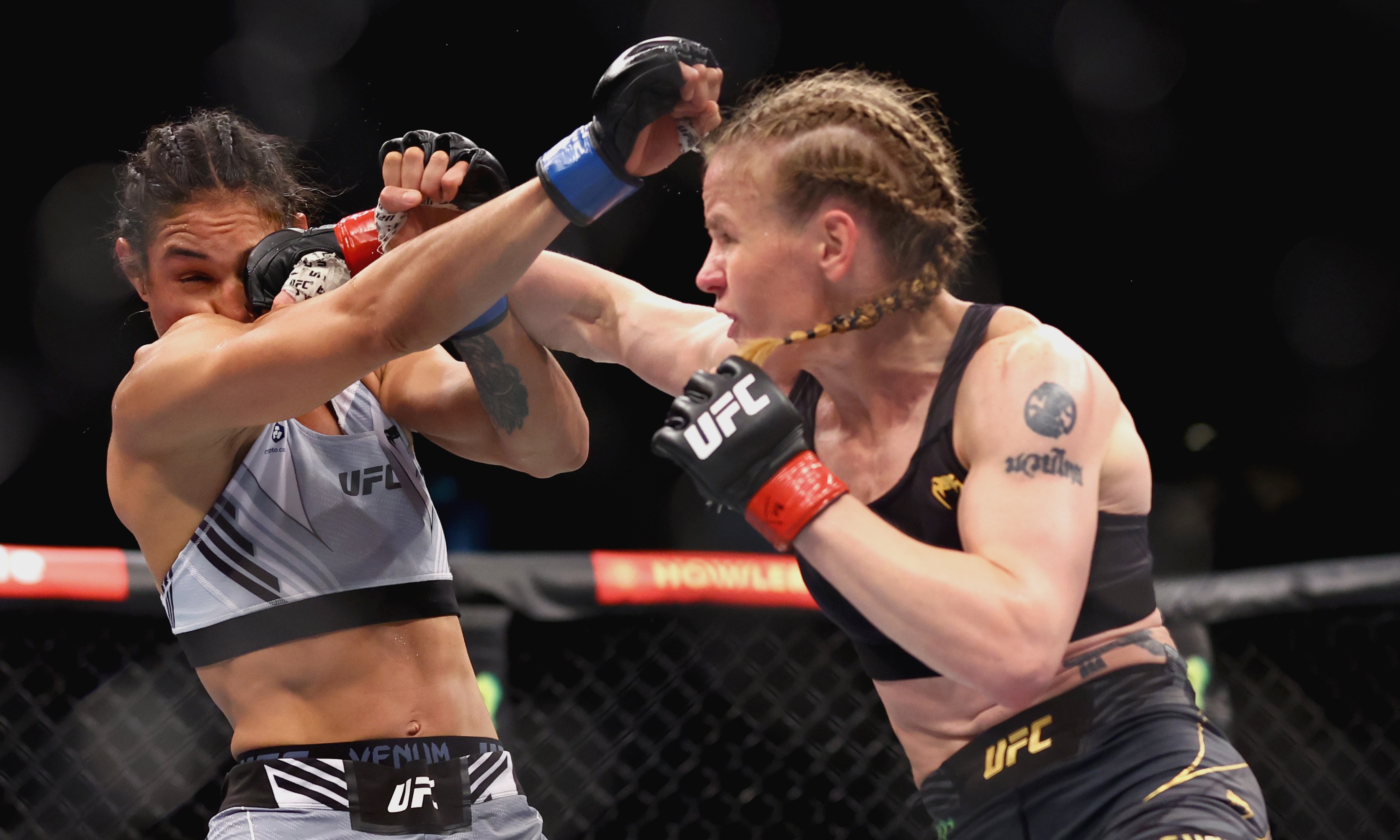 SINGAPORE, SINGAPORE - JUNE 12: Valentina Shevchenko of Kyrgyzstan exchanges strikes with Taila Santos of Brazil during their Women's Flyweight Fight at Singapore Indoor Stadium on June 12, 2022 in Singapore. (Photo by Yong Teck Lim/Getty Images)