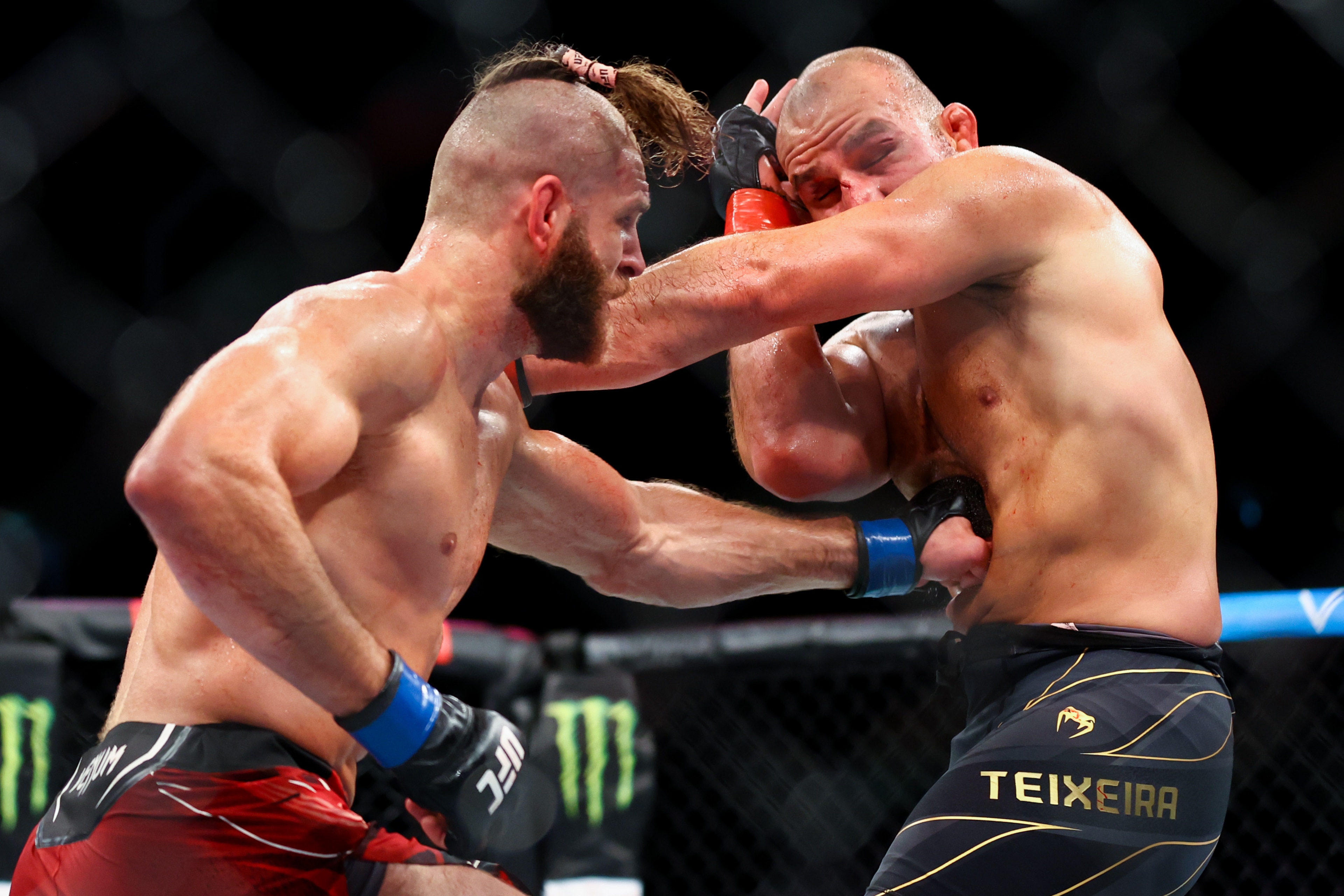 SINGAPORE, SINGAPORE - JUNE 12: Glover Teixeira of Brazil exchanges strikes with Jiri Prochazka of Czech Republic during their light Heavyweight Championship Fight at Singapore Indoor Stadium on June 12, 2022 in Singapore. (Photo by Yong Teck Lim/Getty Images) SINGAPORE, SINGAPORE - JUNE 12: Glover Teixeira of Brazil exchanges strikes with Jiri Prochazka of Czech Republic during their light Heavyweight Championship Fight at Singapore Indoor Stadium on June 12, 2022 in Singapore. (Photo by Yong Teck Lim/Getty Images)