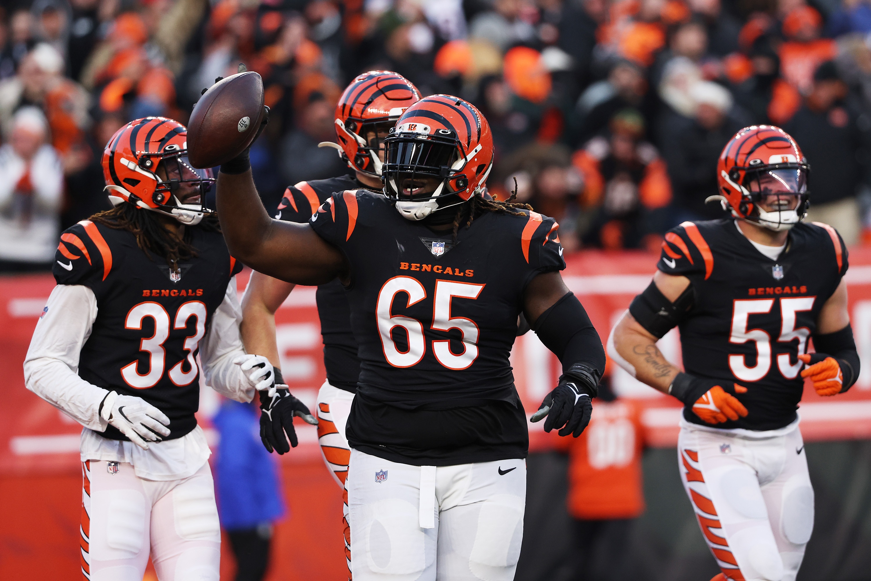 CINCINNATI, OHIO - JANUARY 15: Defensive tackle Larry Ogunjobi #65 of the Cincinnati Bengals celebrates after recovering a first half fumble against the Las Vegas Raiders during the AFC Wild Card playoff game at Paul Brown Stadium on January 15, 2022 in Cincinnati, Ohio. (Photo by Dylan Buell/Getty Images)