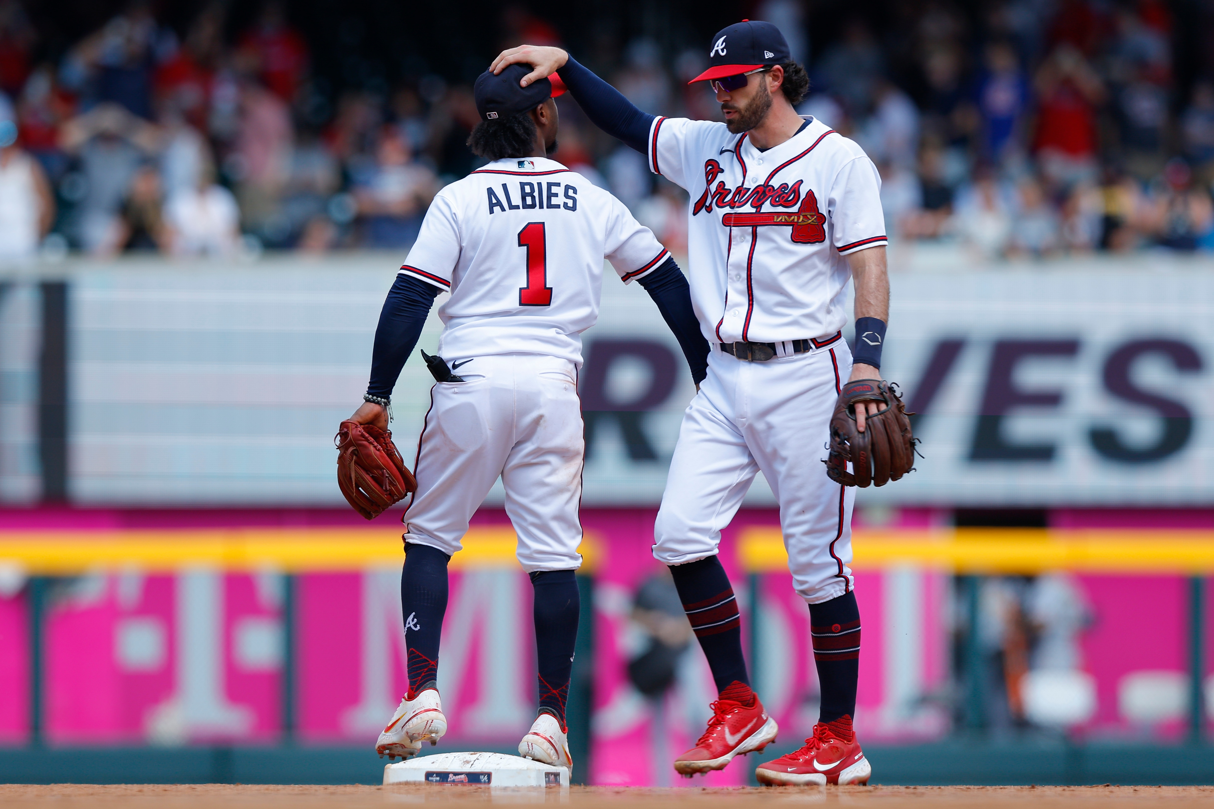ATLANTA, GA - JUNE 12:  Dansby Swanson #7 reacts with Ozzie Albies #1 of the Atlanta Braves after their 5-3 win against the Pittsburgh Pirates at Truist Park on June 12, 2022 in Atlanta, Georgia. (Photo by Todd Kirkland/Getty Images)