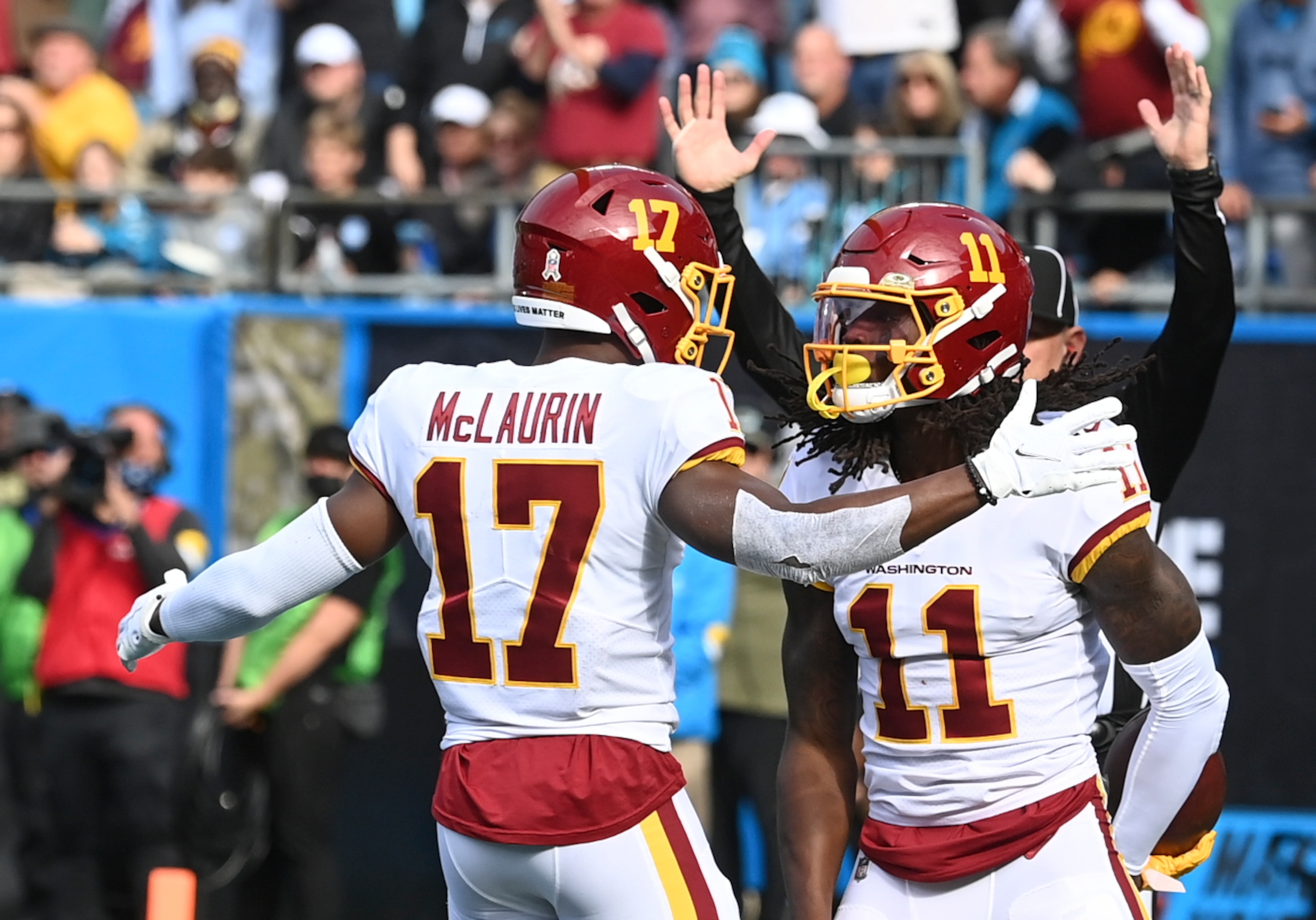 CHARLOTTE, NC - NOVEMBER 21:  Washington Football Team wide receiver Terry McLaurin (17) congratulates Washington Football Team wide receiver Cam Sims (11) after his second quarter touchdown during the game between the Washington Football team and Carolina Panthers at Bank of America Stadium. (Photo by Jonathan Newton/The Washington Post via Getty Images)