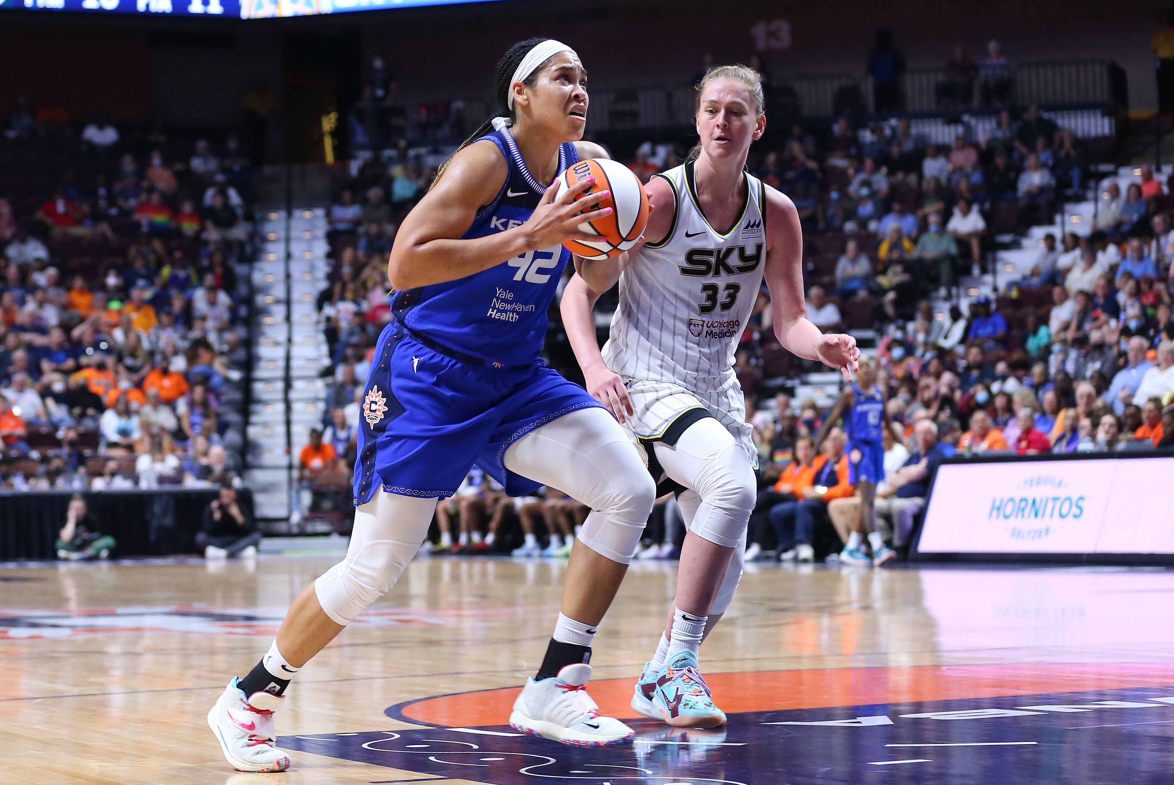 UNCASVILLE, CT - JUNE 10: Connecticut Sun center Brionna Jones (42) drives to the basket against Chicago Sky forward Emma Meesseman (33) during the WNBA game between Chicago Sky and Connecticut Sun on June 10, 2022, at Mohegan Sun Arena in Uncasville, CT. (Photo by M. Anthony Nesmith/Icon Sportswire via Getty Images)