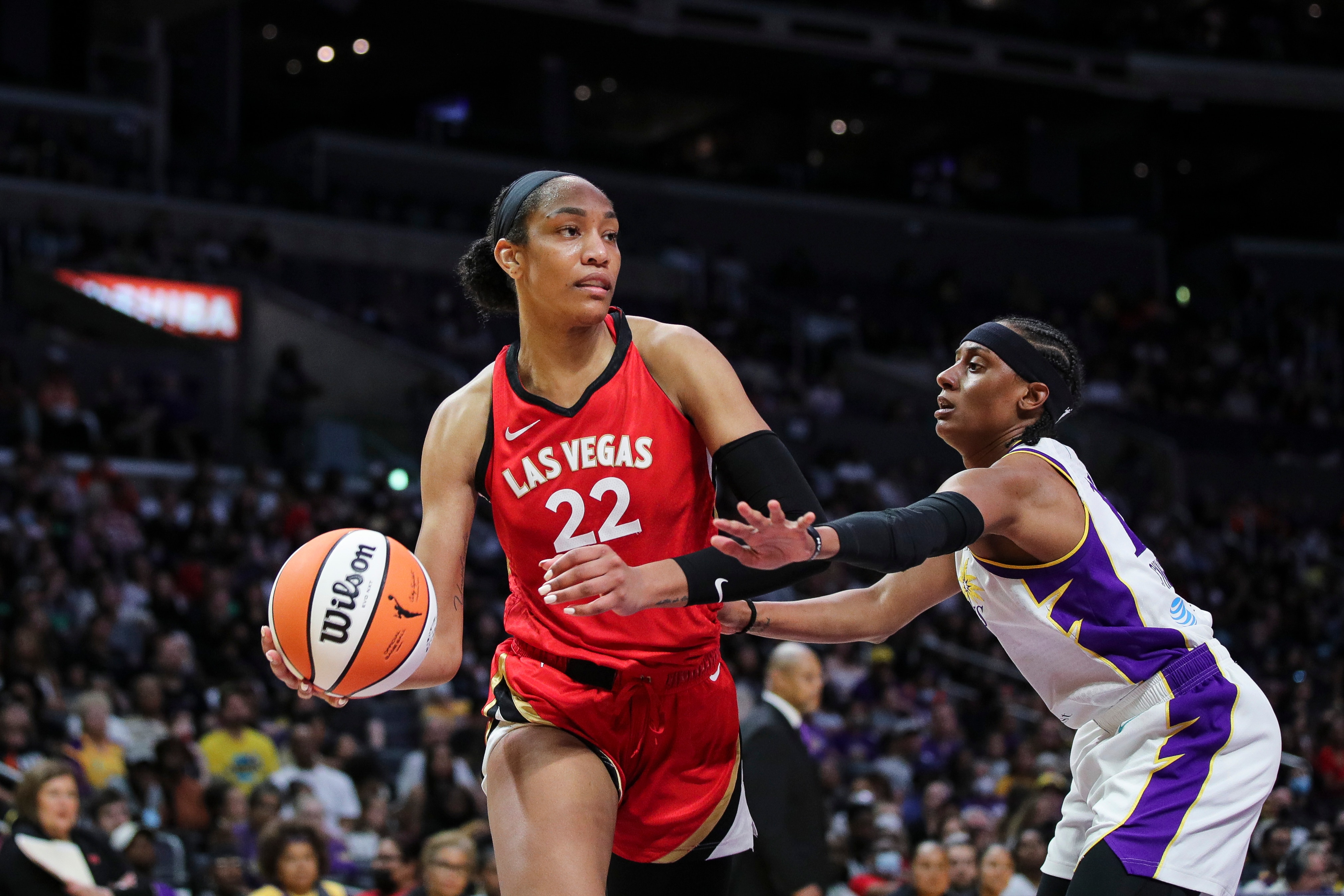 LOS ANGELES, CALIFORNIA - JUNE 11: Forward A'ja Wilson #22 of the Las Vegas Aces looks to pass the ball while defended by guard Brittney Sykes #15 of the Los Angeles Sparks at Crypto.com Arena on June 11, 2022 in Los Angeles, California. NOTE TO USER: User expressly acknowledges and agrees that, by downloading and or using this photograph, User is consenting to the terms and conditions of the Getty Images License Agreement. (Photo by Meg Oliphant/Getty Images)