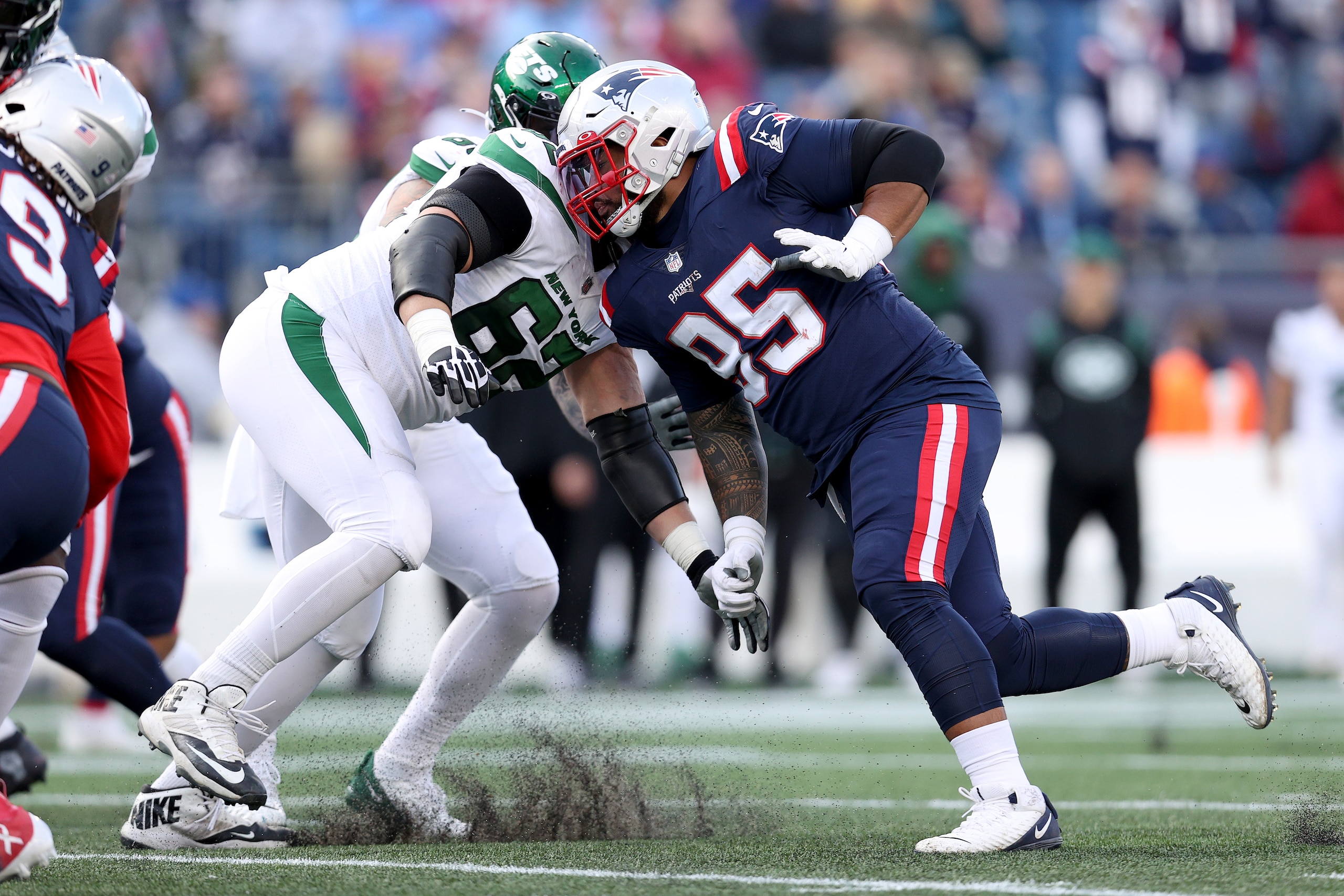 FOXBOROUGH, MASSACHUSETTS - OCTOBER 24: Daniel Ekuale #95 of the New England Patriots rushes against Greg Van Roten #62 of the New York Jets during the game at Gillette Stadium on October 24, 2021 in Foxborough, Massachusetts. (Photo by Maddie Meyer/Getty Images)