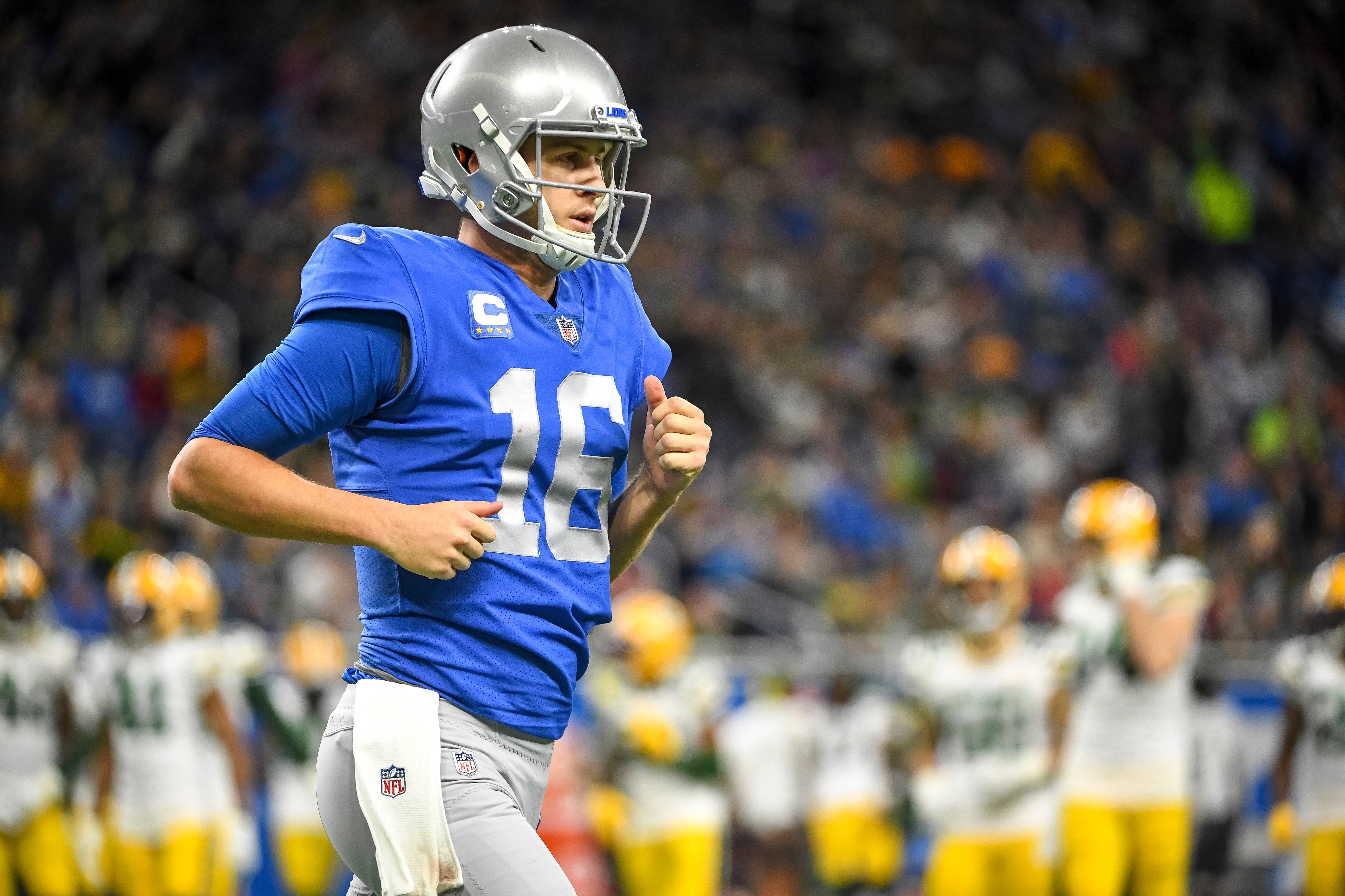 DETROIT, MICHIGAN - JANUARY 09: Jared Goff #16 of the Detroit Lions runs to the sideline against the Green Bay Packers at Ford Field on January 09, 2022 in Detroit, Michigan. (Photo by Nic Antaya/Getty Images)