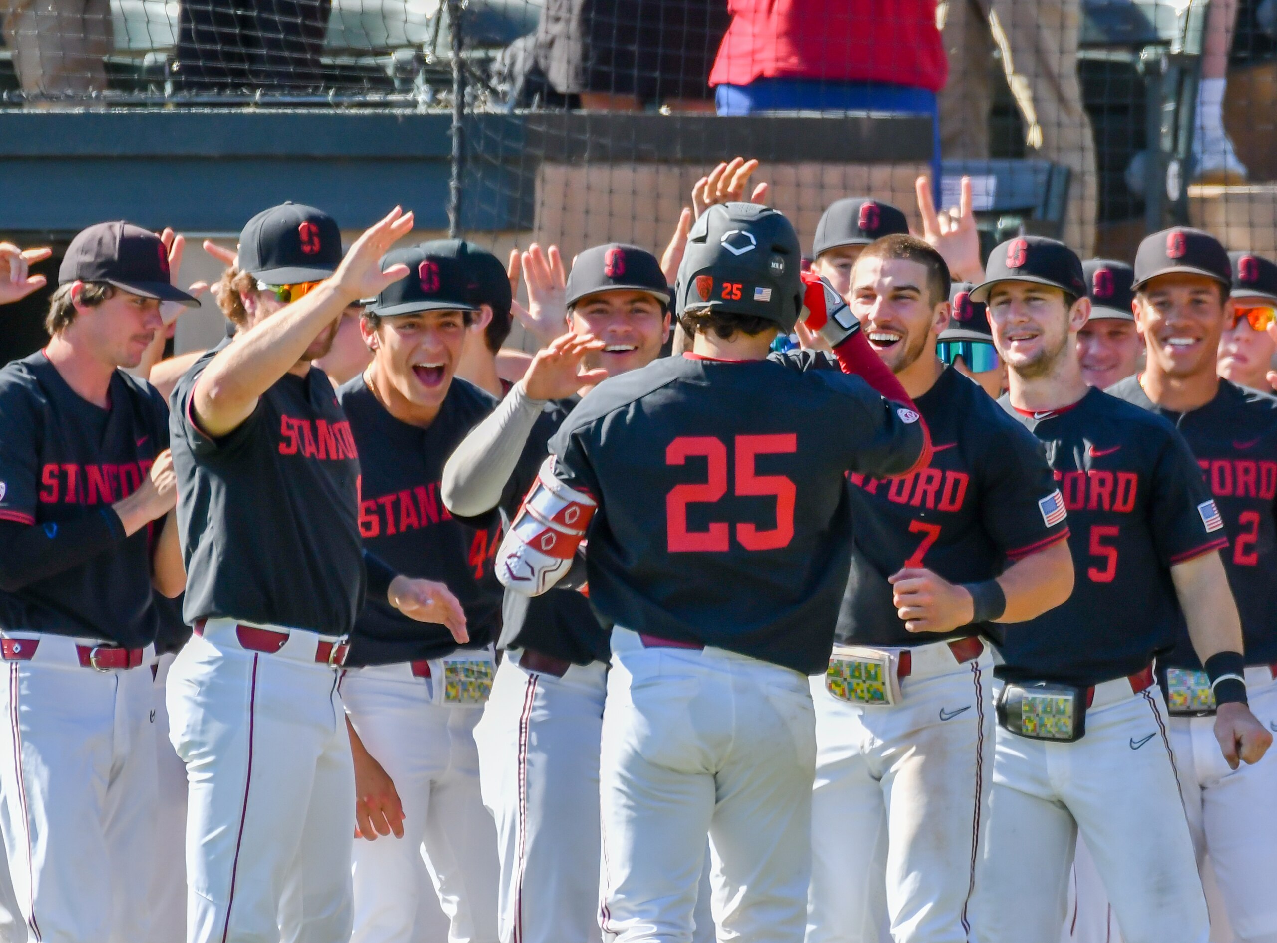 STANFORD, CA - MARCH 26: An enthusiastic Stanford Cardinal team await Stanford Cardinal catcher Kody Huff (25) return to the dugout after hitting a 2-run home run during the game between the Washington State Cougars and the Stanford Cardinal on Saturday, March 26, 2022 at Klein Field in Palo Alto, California. (Photo by Douglas Stringer/Icon Sportswire via Getty Images)