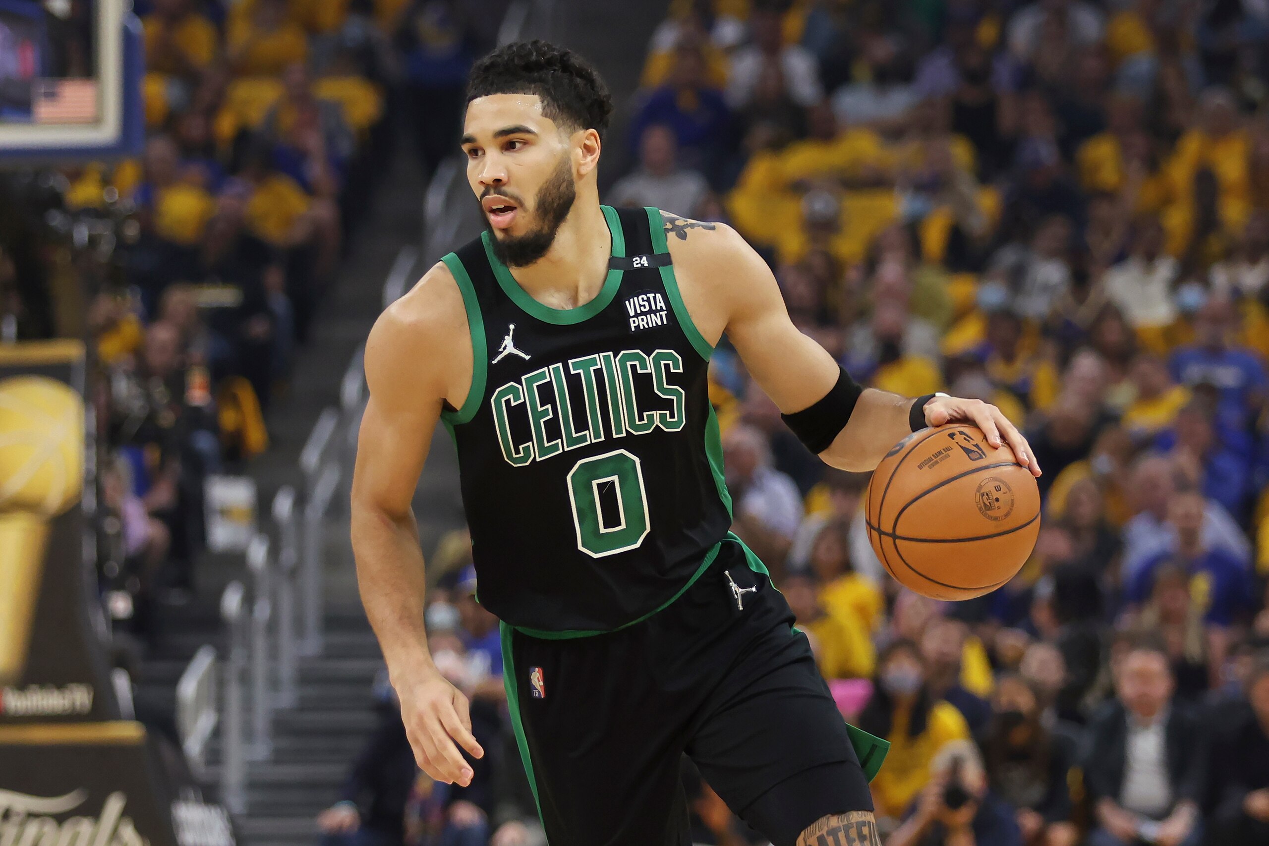 Boston Celtics forward Jayson Tatum (0) brings the ball up the court against the Golden State Warriors during the first half of Game 5 of basketball's NBA Finals in San Francisco, Monday, June 13, 2022. (AP Photo/Jed Jacobsohn)