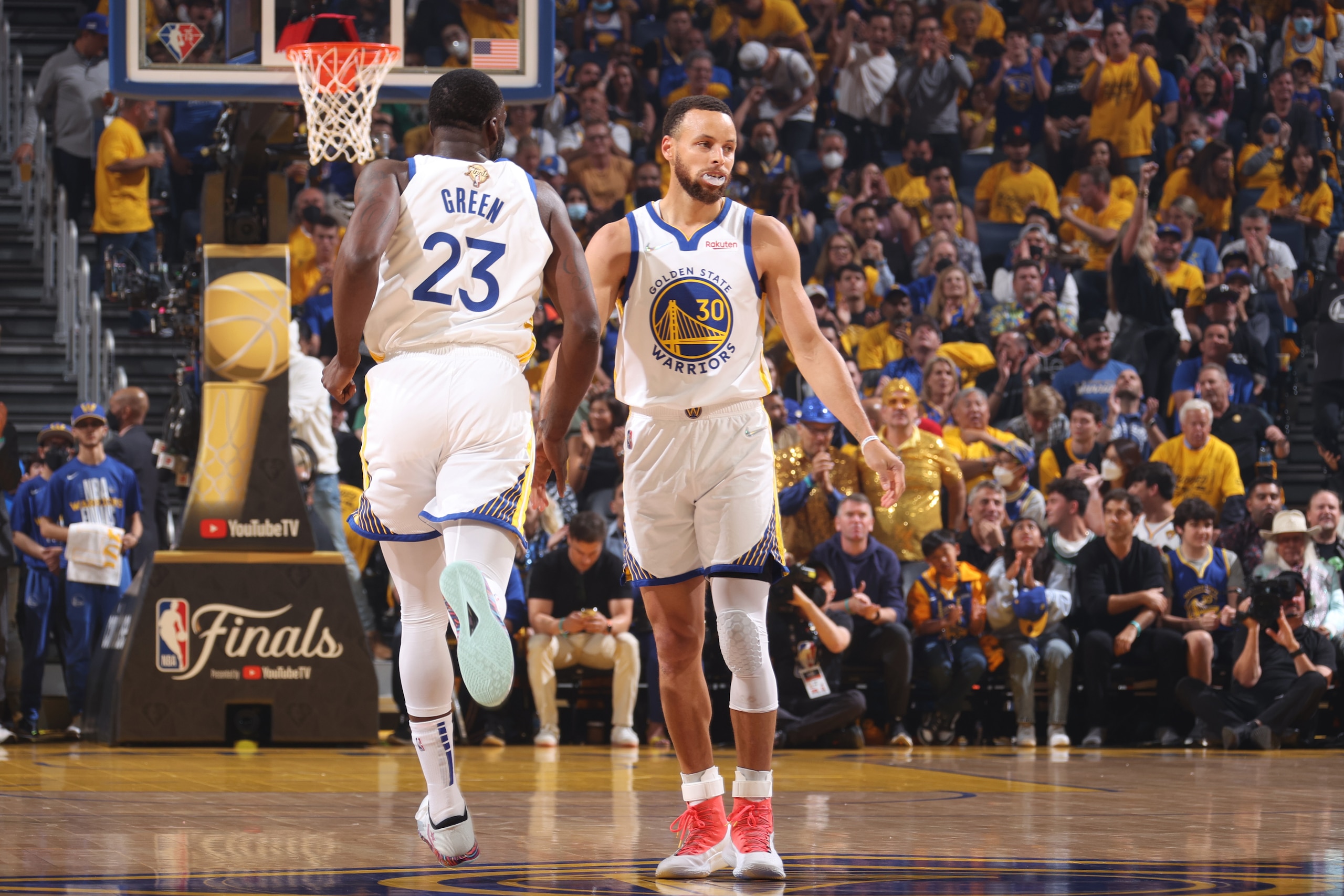 SAN FRANCISCO, CA - JUNE 13: Draymond Green #23 and Stephen Curry #30 of the Golden State Warriors high five during Game Five of the 2022 NBA Finals on June 13, 2022 at Chase Center in San Francisco, California. NOTE TO USER: User expressly acknowledges and agrees that, by downloading and or using this photograph, user is consenting to the terms and conditions of Getty Images License Agreement. Mandatory Copyright Notice: Copyright 2022 NBAE (Photo by Nathaniel S. Butler/NBAE via Getty Images)