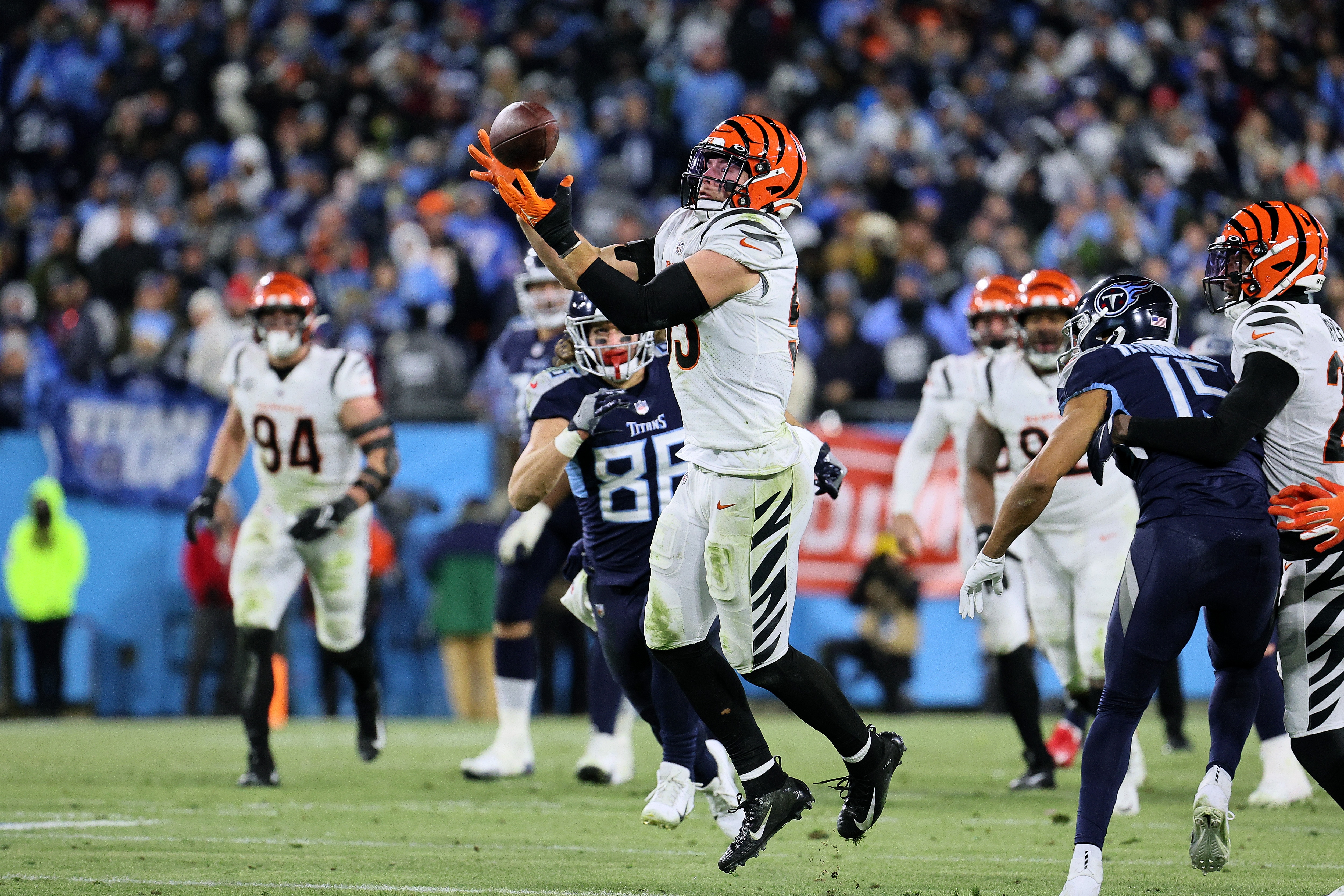 NASHVILLE, TENNESSEE - JANUARY 22: Linebacker Logan Wilson #55 of the Cincinnati Bengals intercepts a Tennessee Titans pass in the fourth quarter of the AFC Divisional Playoff game at Nissan Stadium on January 22, 2022 in Nashville, Tennessee. (Photo by Andy Lyons/Getty Images)