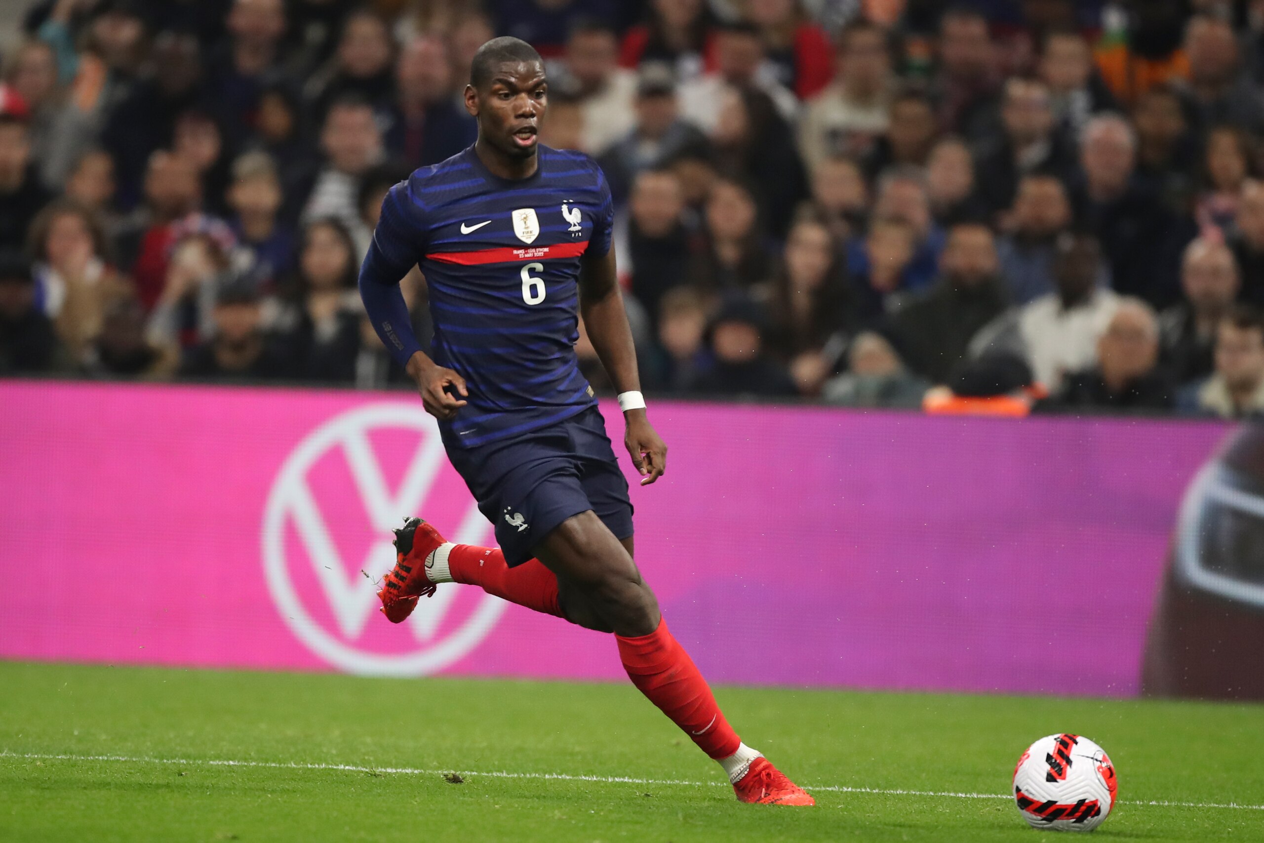 France's Paul Pogba runs with the ball during an international friendly soccer match between France and Cote d'Ivoire at the Velodrome stadium in Marseille, southern France, Friday, March 25, 2022. (AP Photo/Daniel Cole)