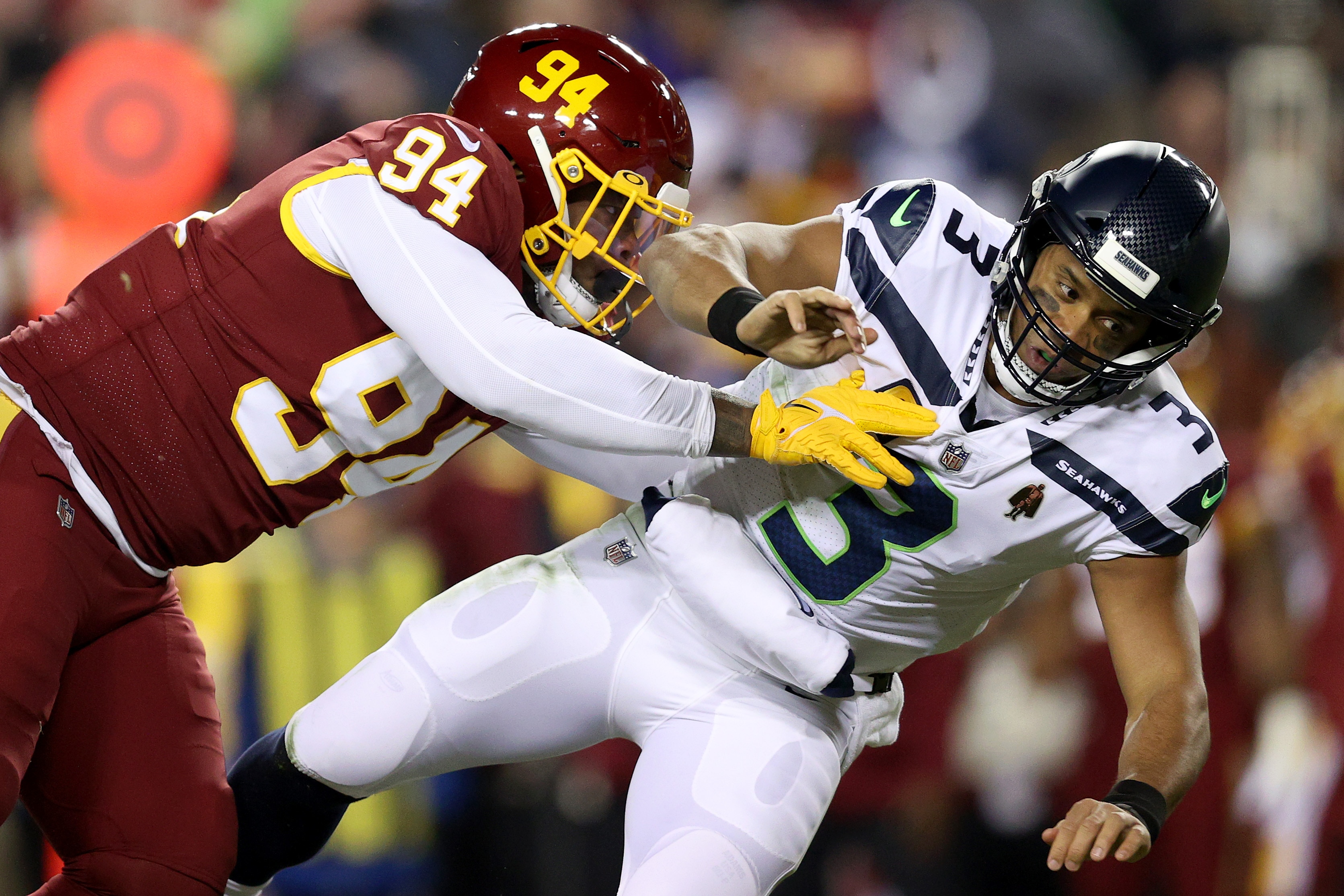 LANDOVER, MARYLAND - NOVEMBER 29: Daron Payne #94 of the Washington Football Team sacks Russell Wilson #3 of the Seattle Seahawks in the first quarter of the game at FedExField on November 29, 2021 in Landover, Maryland. (Photo by Patrick Smith/Getty Images)