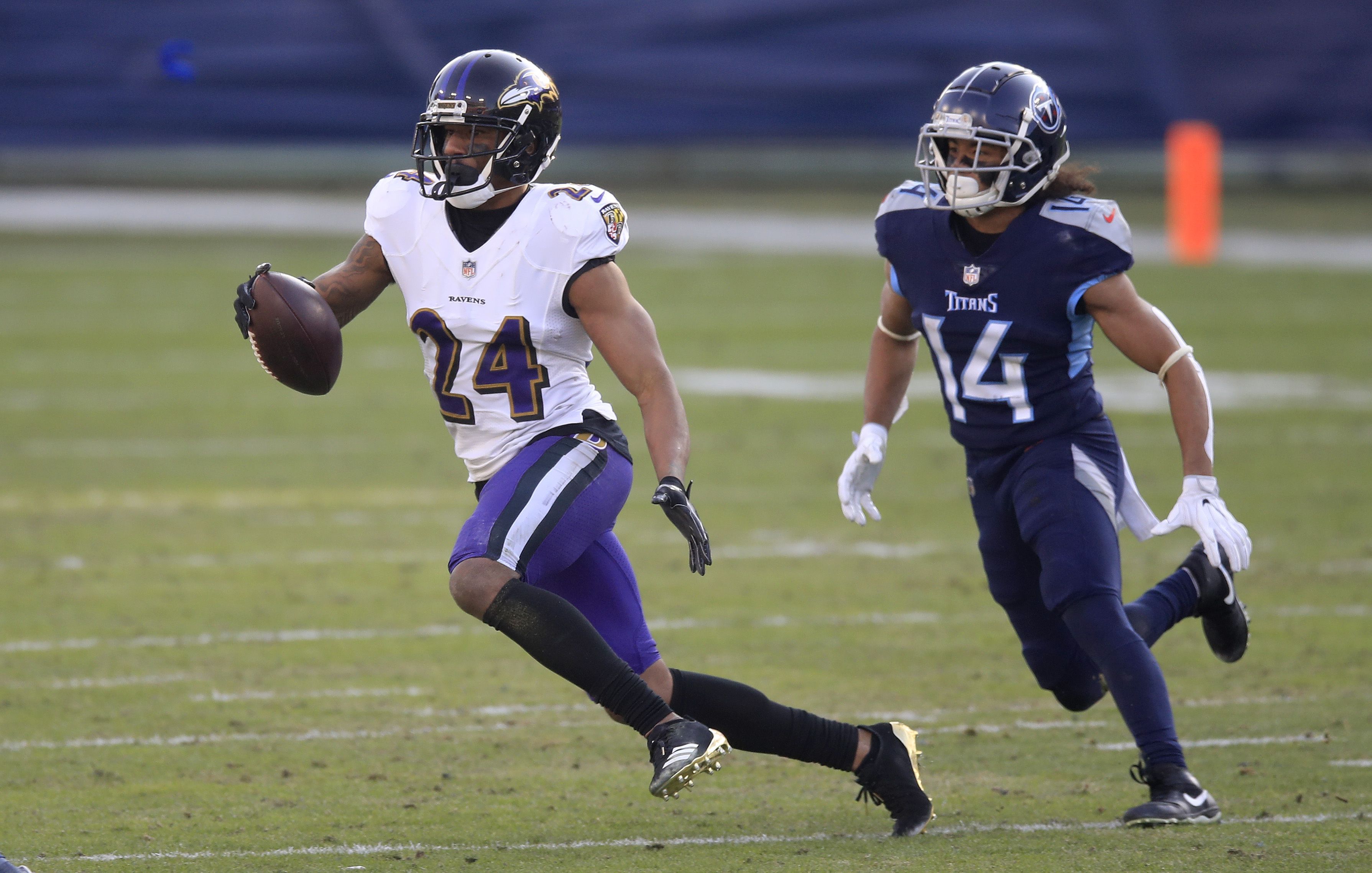 NASHVILLE, TENNESSEE - JANUARY 10:  Marcus Peters #24 of the Baltimore Ravens runs with the ball after intercepting a pass against the Tennessee Titans in the Wild Card Round of the NFL Playoffs at Nissan Stadium on January 10, 2021 in Nashville, Tennessee. (Photo by Andy Lyons/Getty Images)