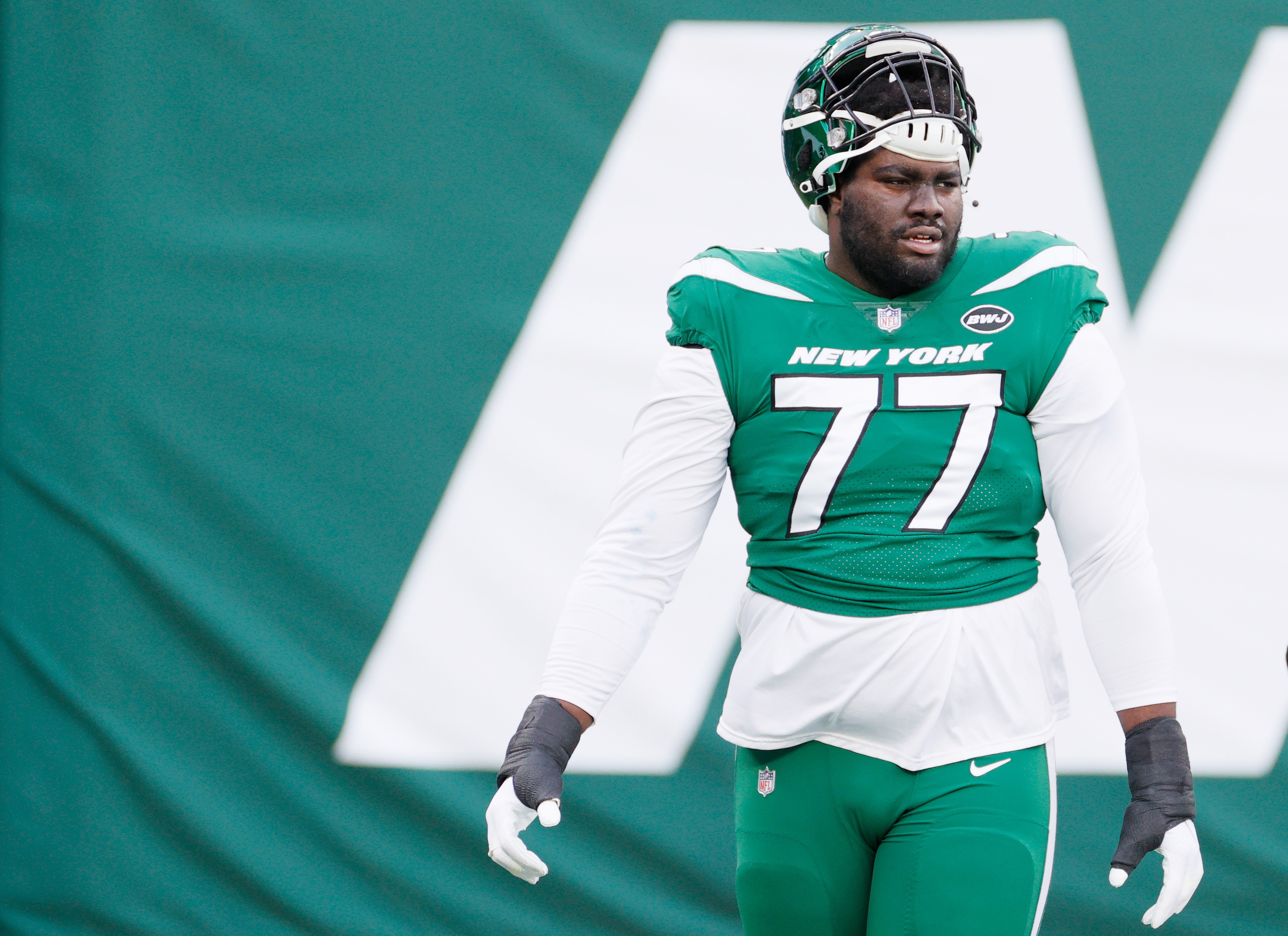 EAST RUTHERFORD, NEW JERSEY - DECEMBER 27: Mekhi Becton #77 of the New York Jets warms up prior to their game against the Cleveland Browns at MetLife Stadium on December 27, 2020 in East Rutherford, New Jersey. (Photo by Sarah Stier/Getty Images)