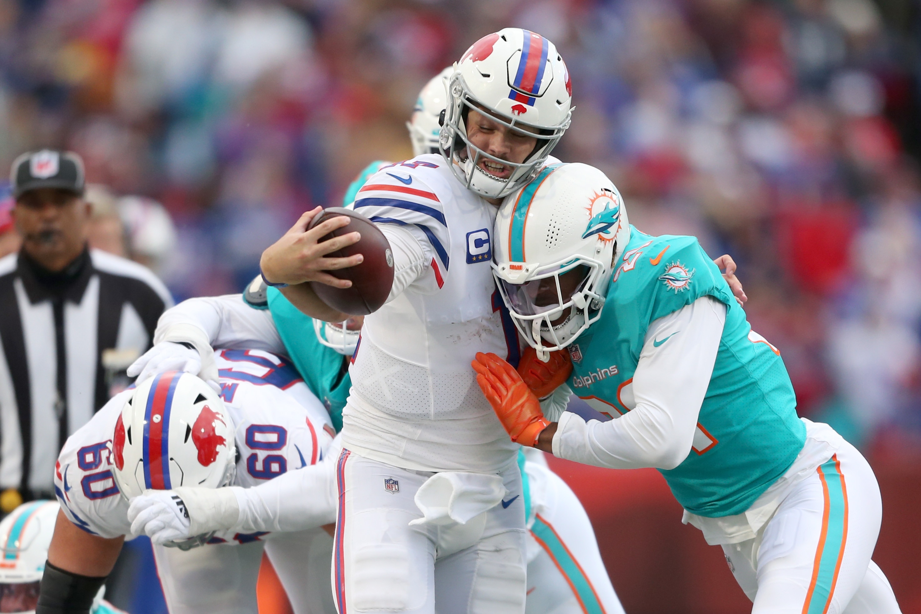 ORCHARD PARK, NEW YORK - OCTOBER 31: Josh Allen #17 of the Buffalo Bills runs with the ball while being tackled by Eric Rowe #21 of the Miami Dolphins in the fourth quarter at Highmark Stadium on October 31, 2021 in Orchard Park, New York. (Photo by Joshua Bessex/Getty Images)