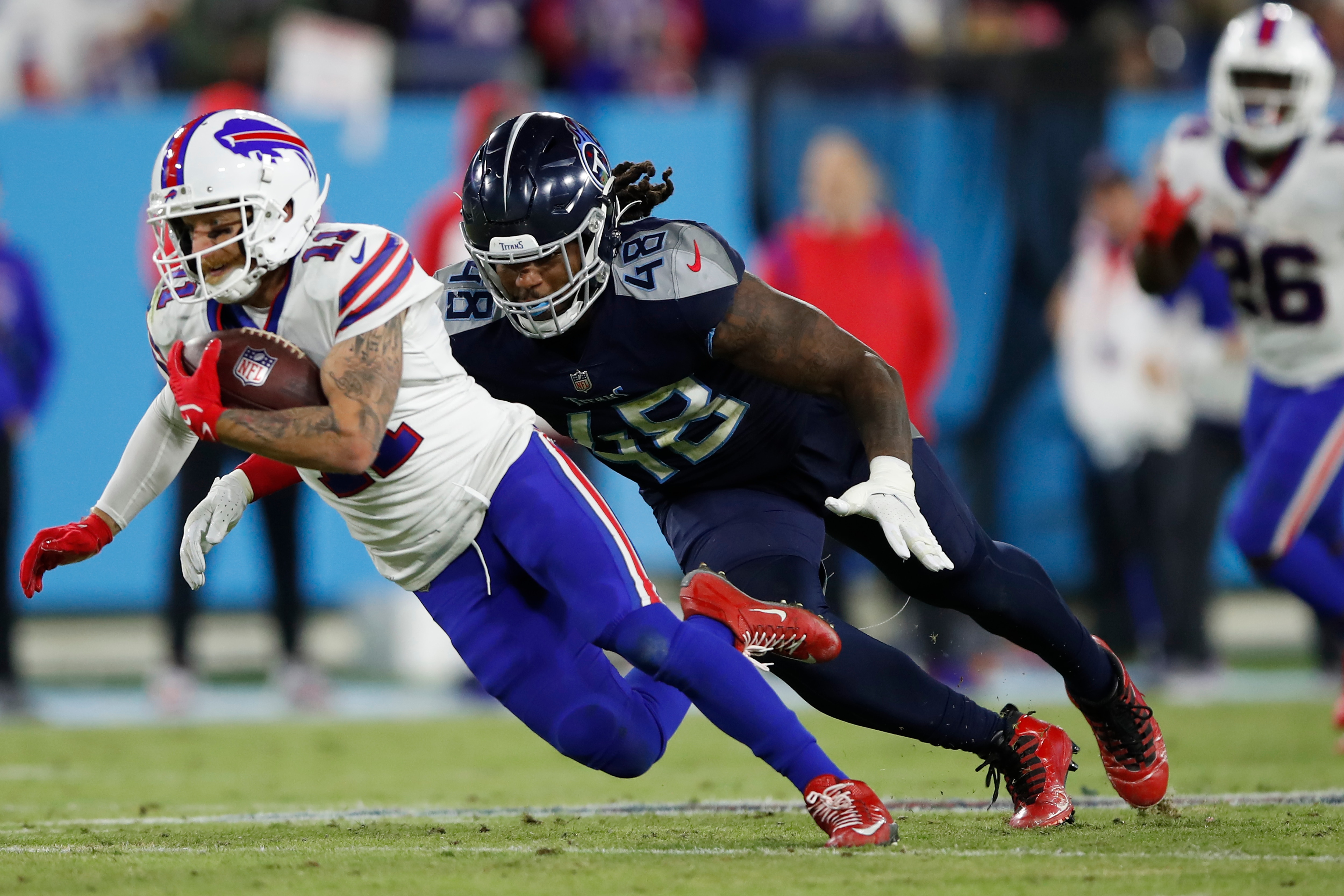 NASHVILLE, TENNESSEE - OCTOBER 18: Wide receiver Cole Beasley #11 of the Buffalo Bills is tackled by outside linebacker Bud Dupree #48 of the Tennessee Titans during the second half at Nissan Stadium on October 18, 2021 in Nashville, Tennessee. (Photo by Wesley Hitt/Getty Images)